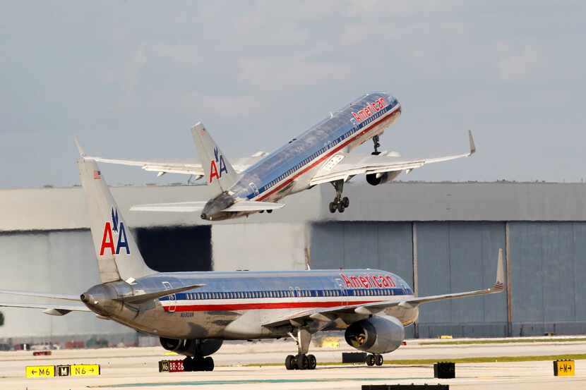 In this Thursday, Oct. 11, 2012 photo, an American Airlines Boeing 757 passenger jet takes...