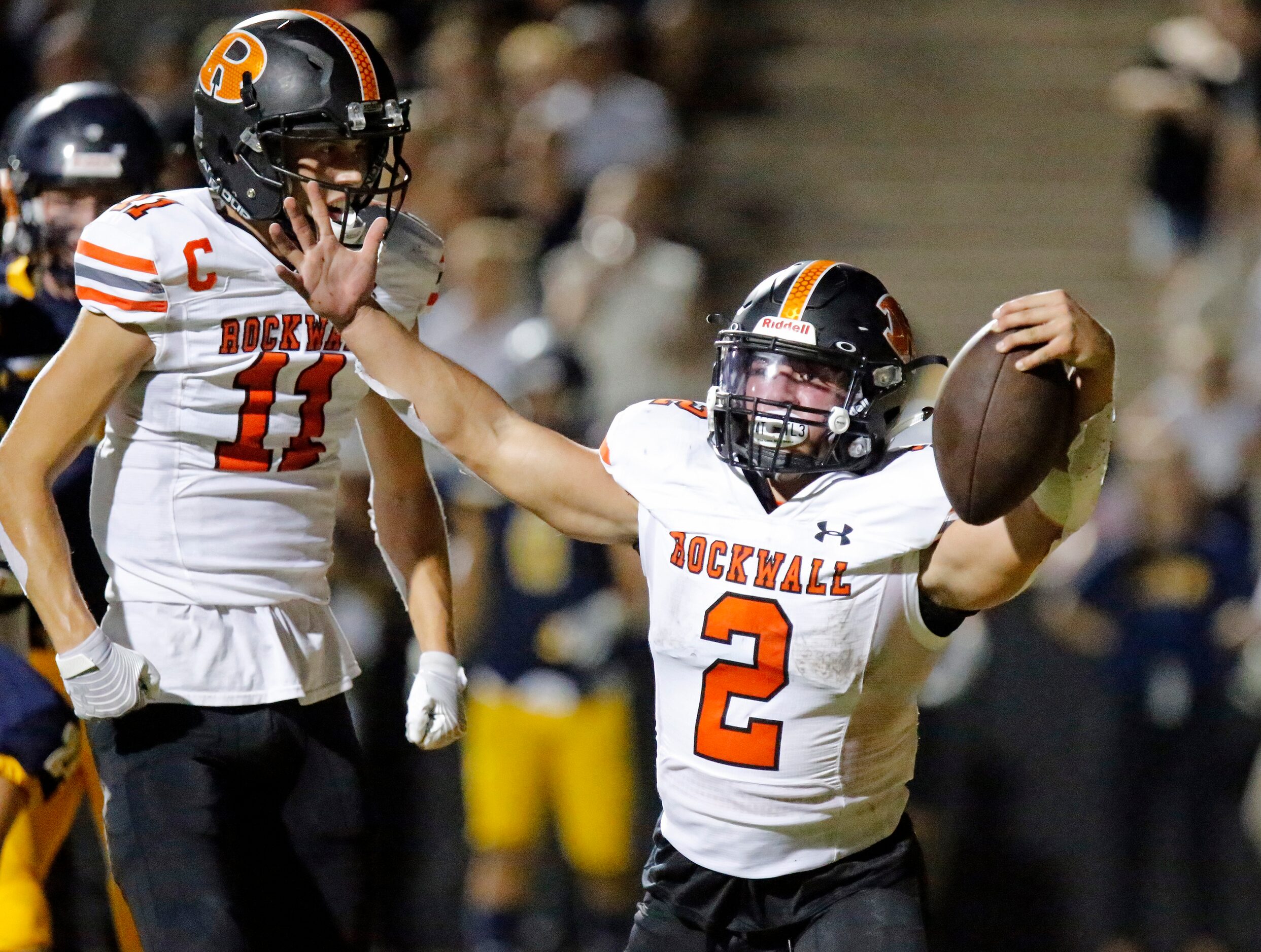 Rockwall High School running back Zach Hernandez (2) celebrates scoring a touchdown as...