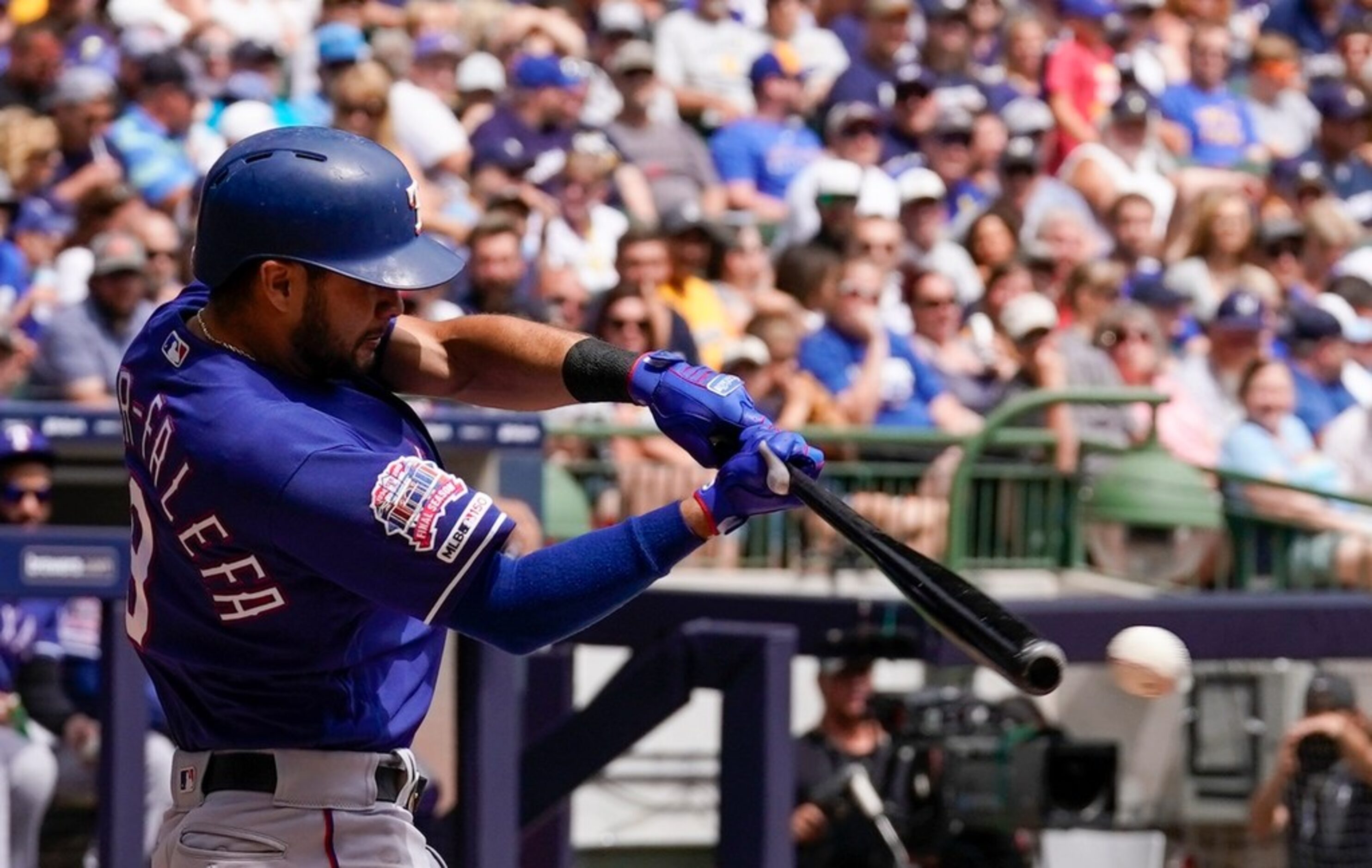 Texas Rangers' Isiah Kiner-Falefa hits a single during the second inning of a baseball game...