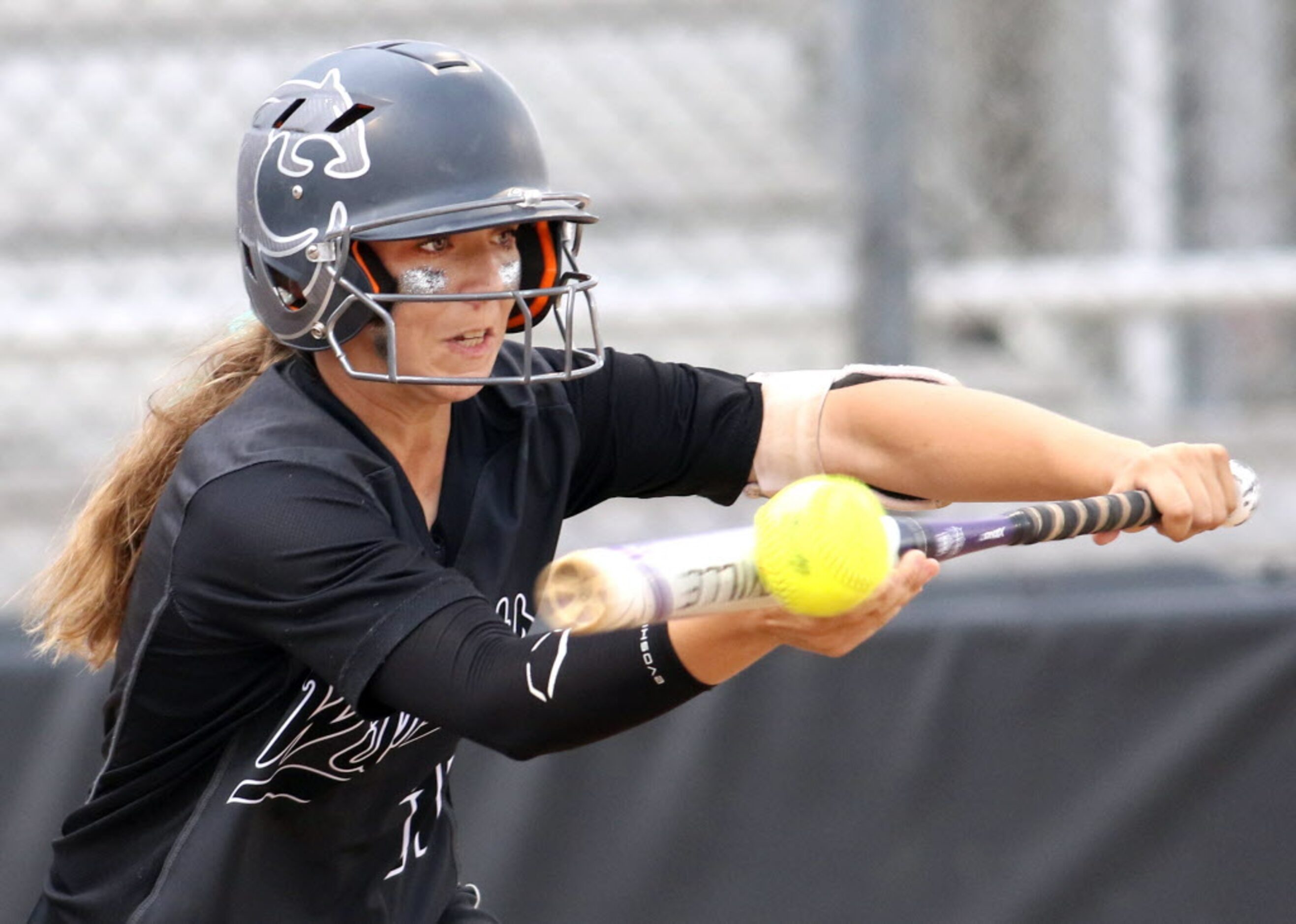 Denton Guyer's Alyssa Dixon (11) maintains sharp focus as she lays down a successful bunt to...