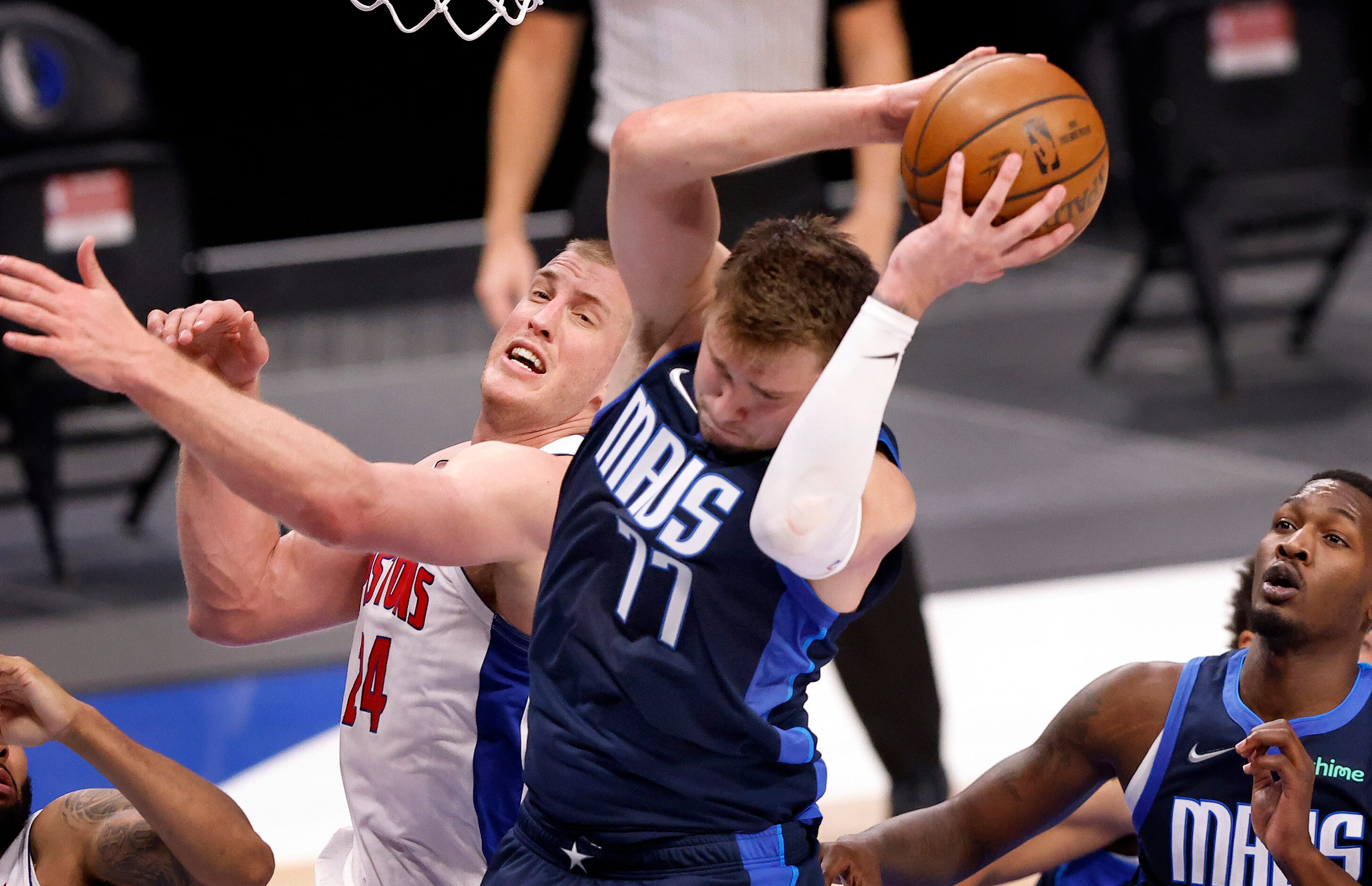 Dallas Mavericks guard Luka Doncic (77) pulls down a defensive rebound against Detroit...