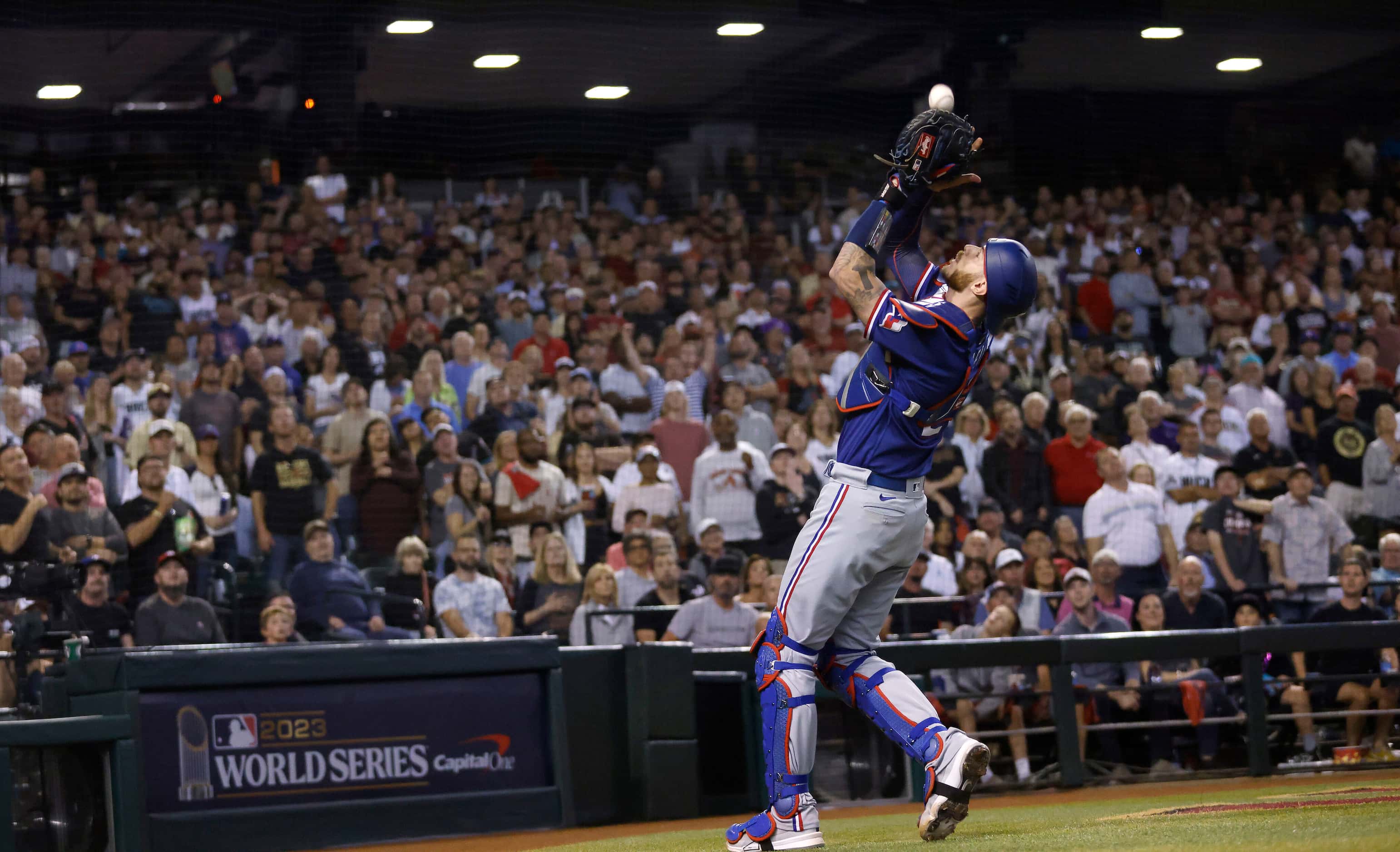 Texas Rangers catcher Jonah Heim (28) catches a foul ball by Arizona Diamondbacks batter...
