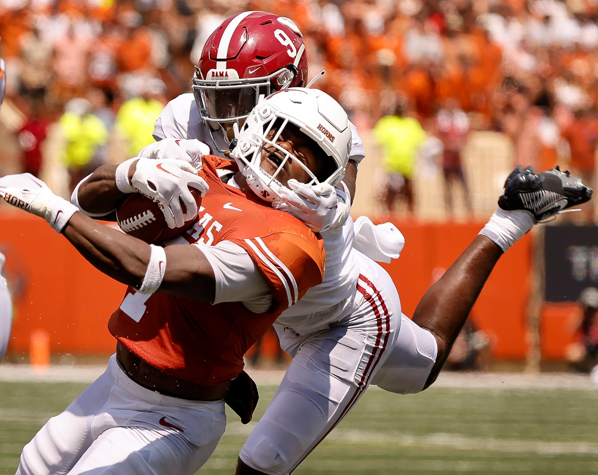 Texas Longhorns running back Keilan Robinson (7) is brought down by his face mask by Alabama...