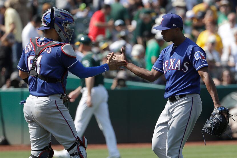 Texas Rangers catcher Robinson Chirinos, left, celebrates with pitcher Jose Leclerc after...