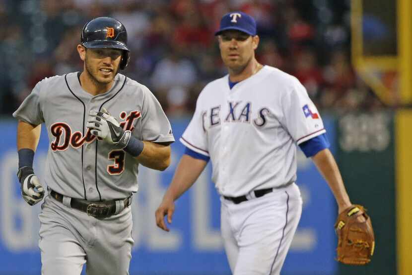 Detroit second baseman Ian Kinsler and Texas starting pitcher Colby Lewis exchange...