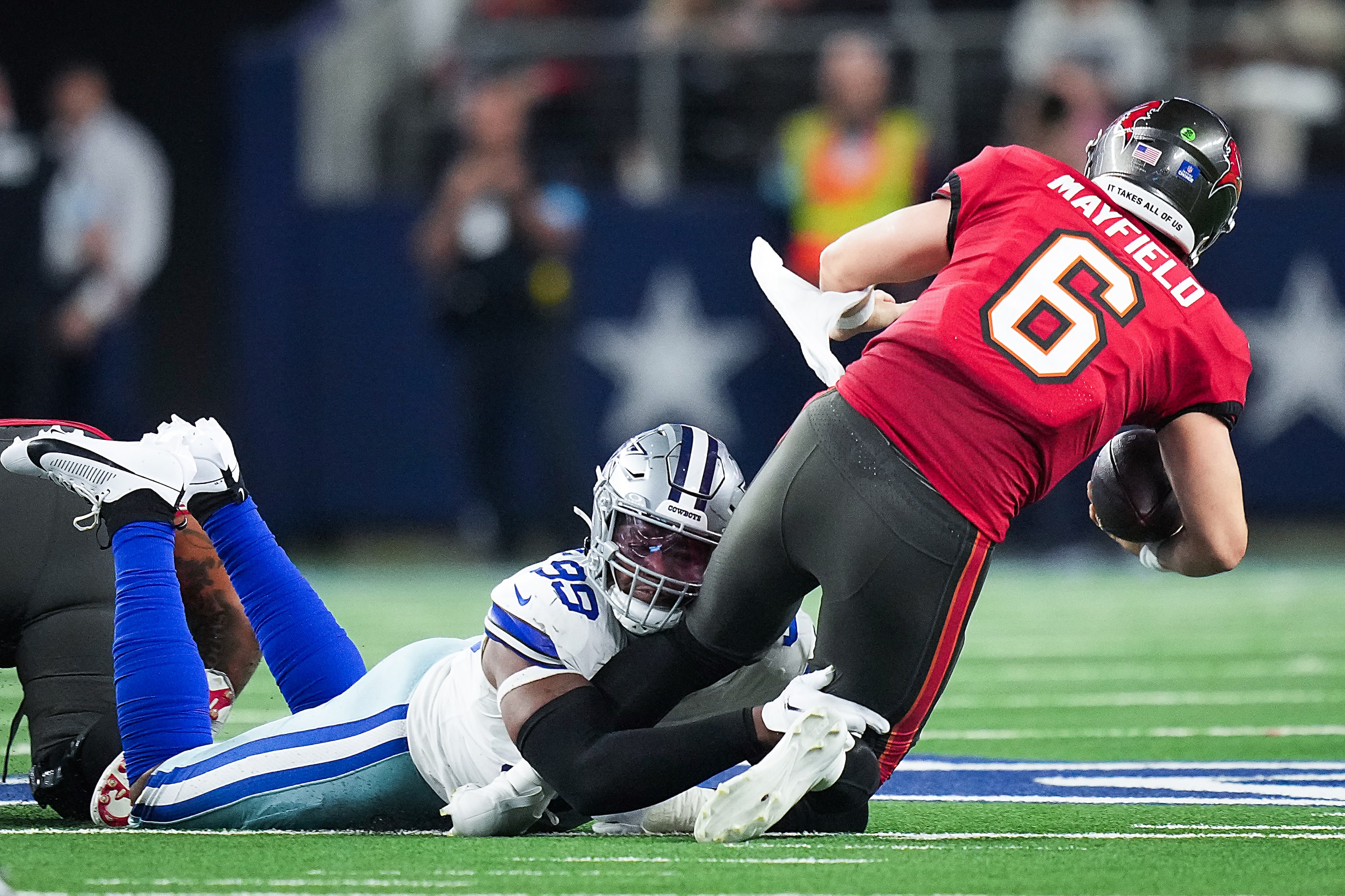 Dallas Cowboys defensive end Chauncey Golston (99) sacks Tampa Bay Buccaneers quarterback...