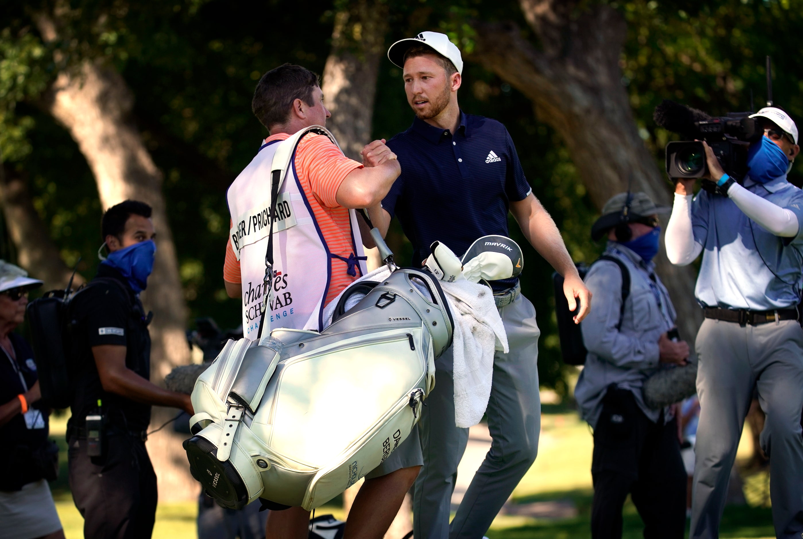 PGA Tour golfer Daniel Berger (right) is congratulated by his caddie Grant Barry after...