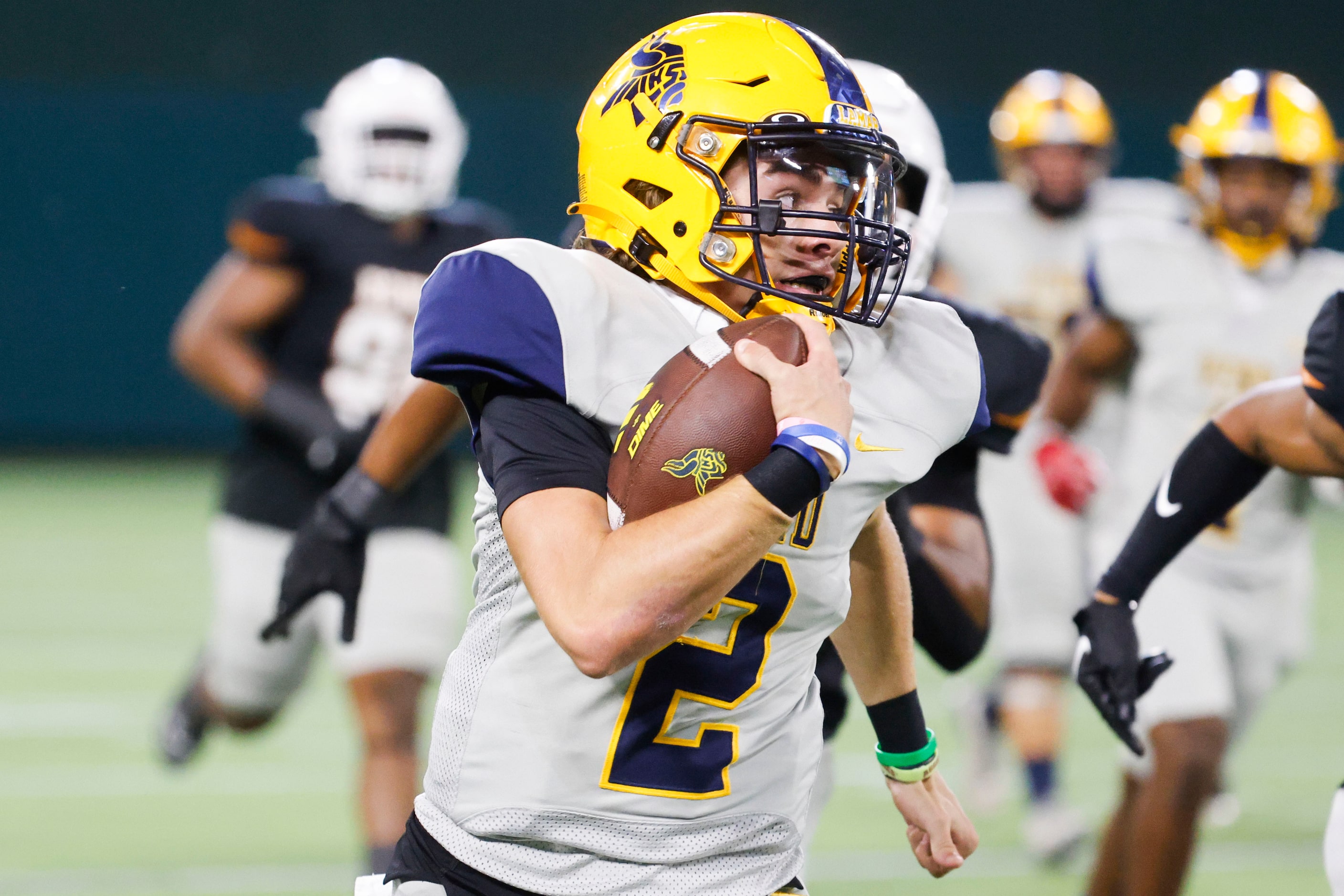 Lamar High’s QB Gannon Carey runs with the ball against James Bowie high during the first...