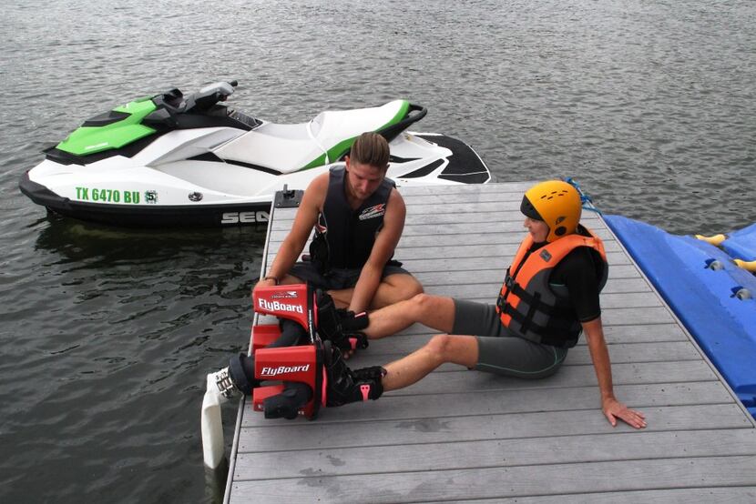 The flyboard platform is strapped on the author's feet prior to being towed into Lake Travis...