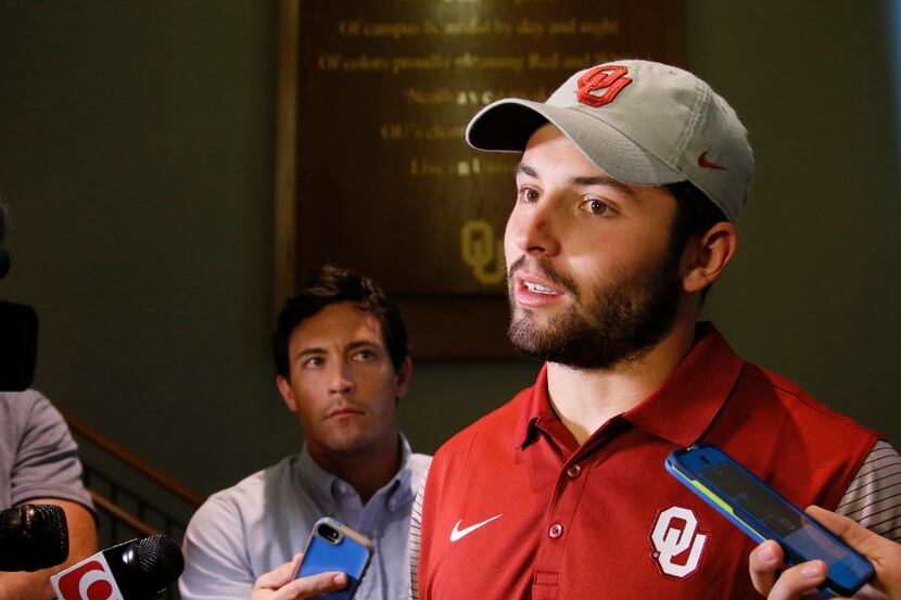 Oklahoma quarterback Baker Mayfield talks with the media following a news conference to...
