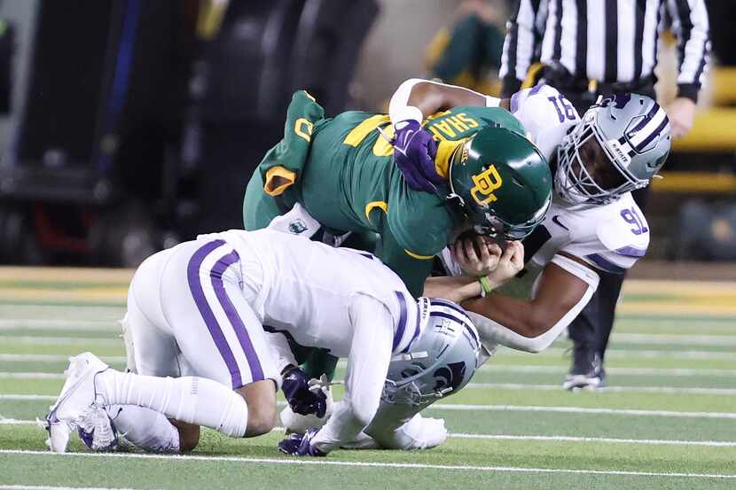 Baylor quarterback Blake Shapen is tackled by Kansas State defensive end Felix...