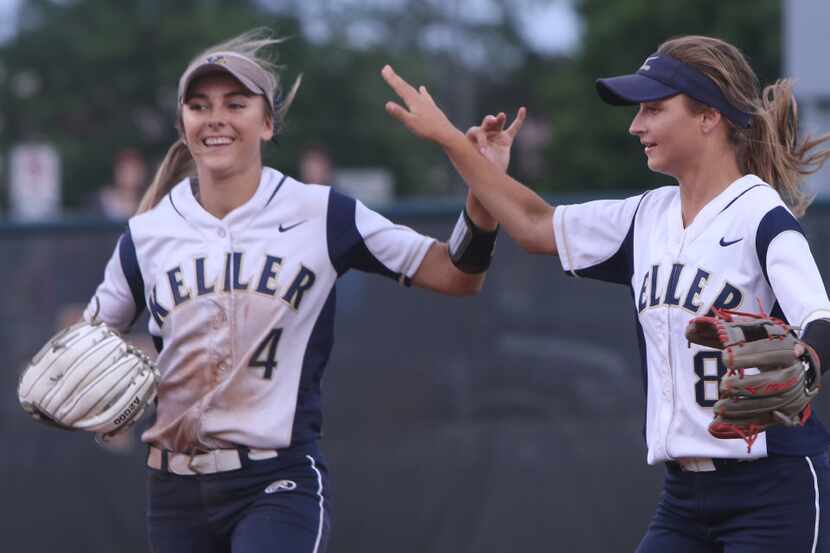 Keller outfielders Amanda Desario (4) and Brook Davis (8) celebrates Davis' catch in right...