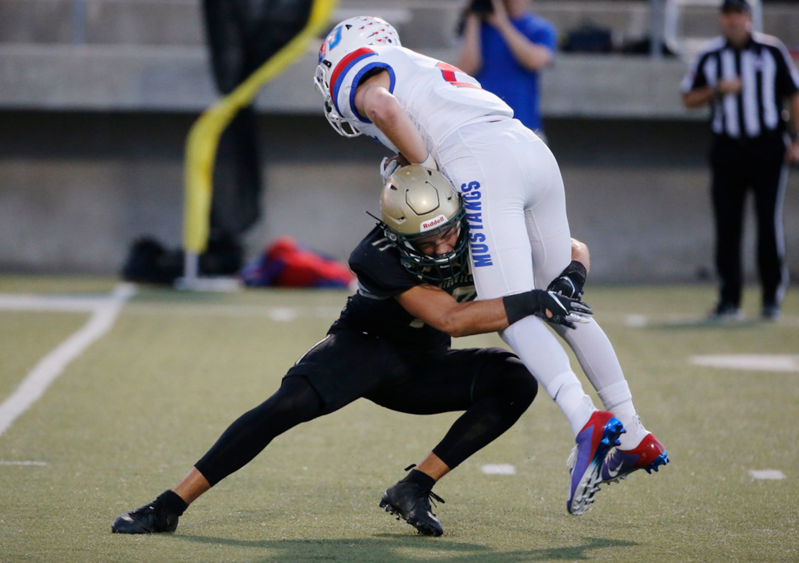 Birdville's Cooper McCasland (17) tackles Grapevine's Caleb Edwards on a kick return during...