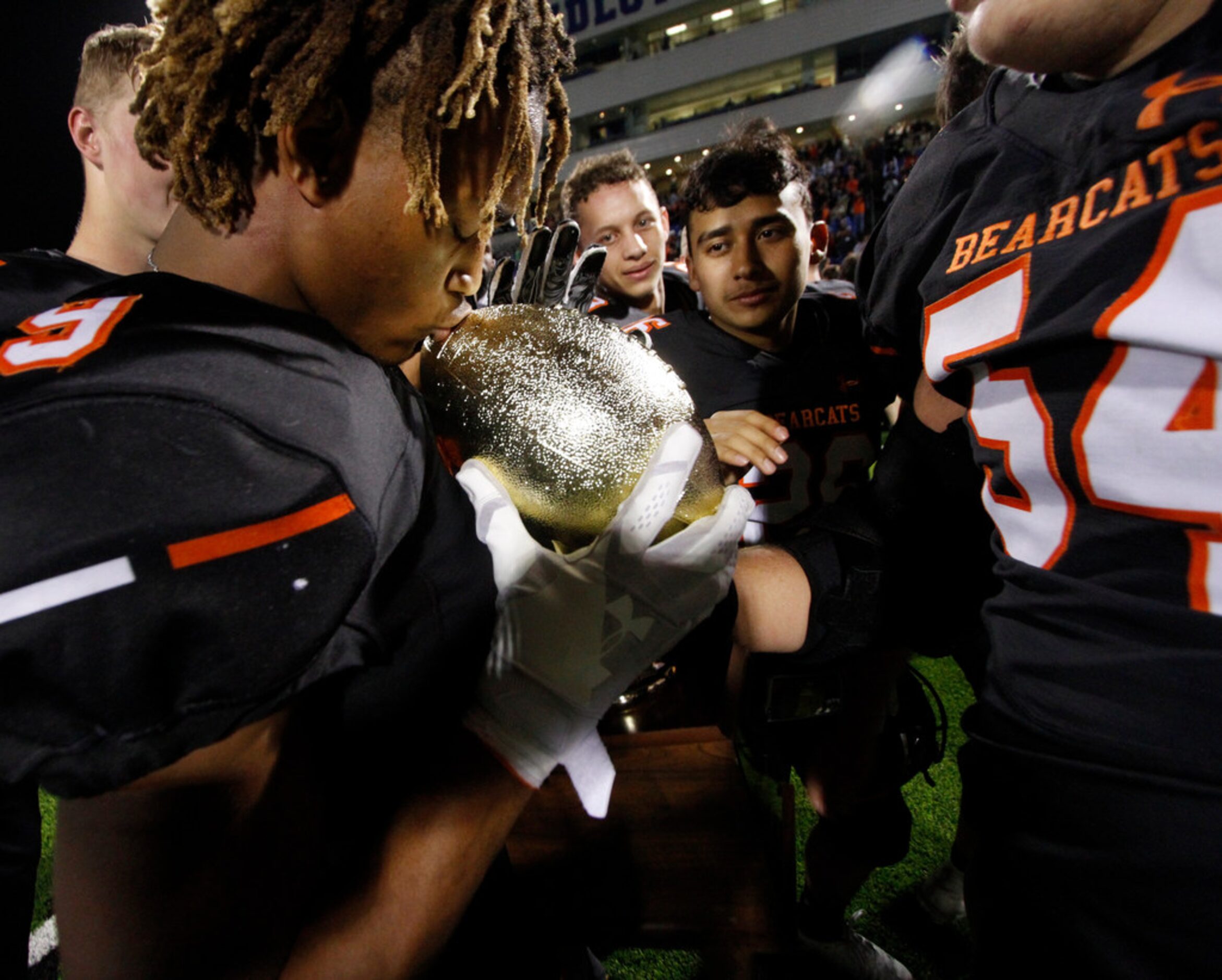 Aledo running back Jase McClellan (9) kisses the Regional semifinal trophy awarded the...