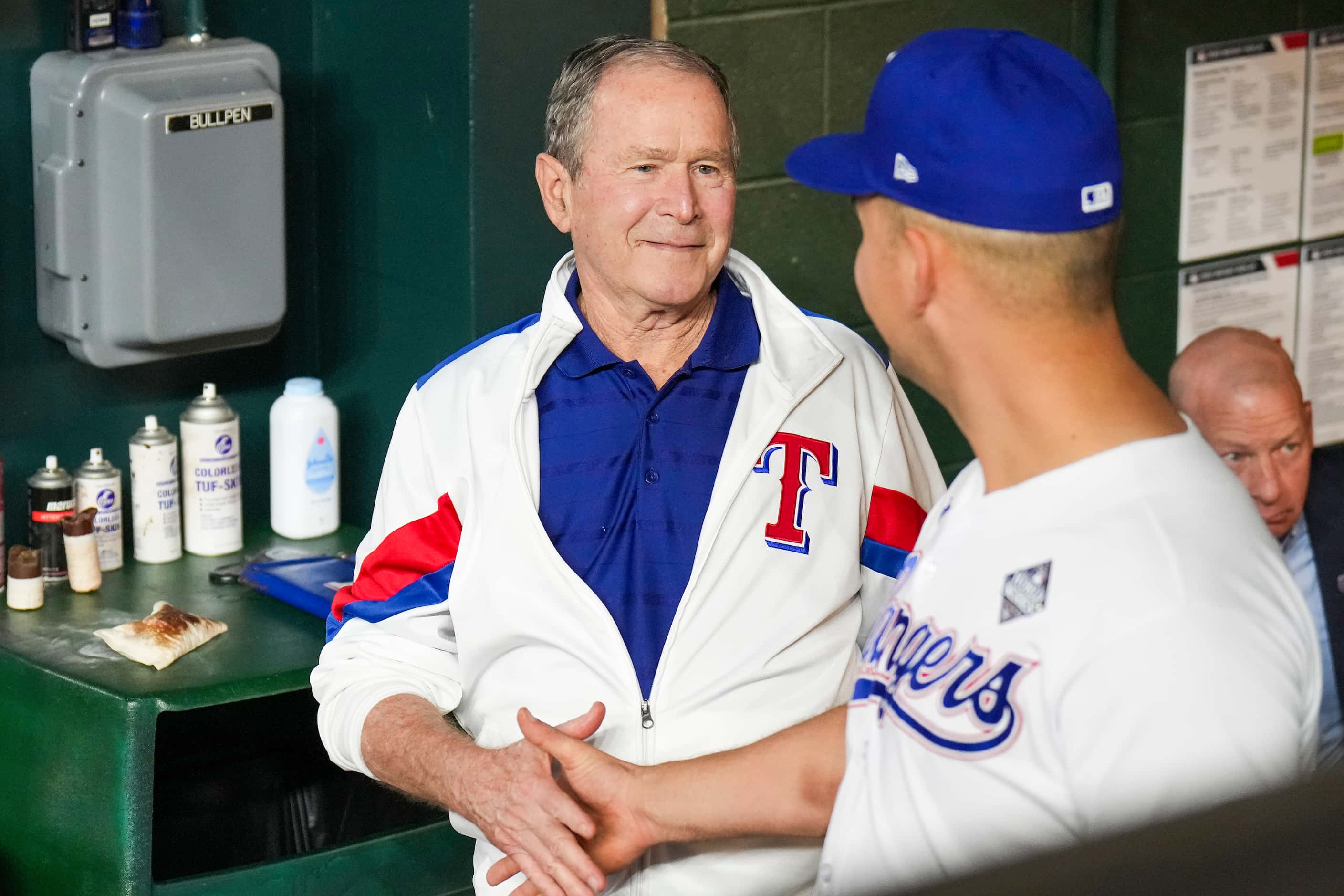 Former President George W. Bush shakes hands with Texas Rangers first baseman Nathaniel Lowe...