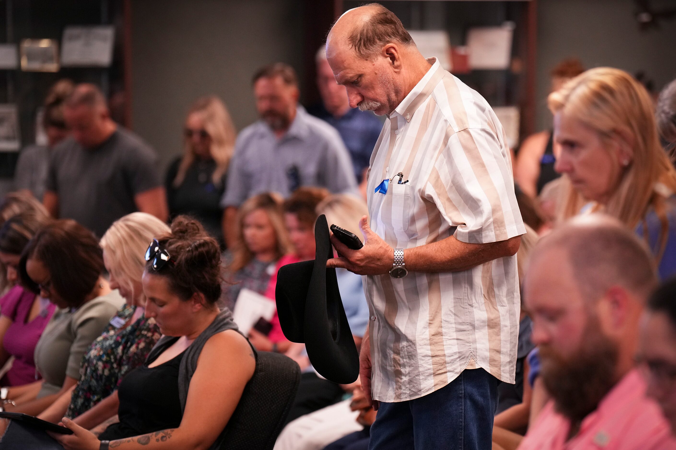 Kyle Sims bows his head during the invocation during a Prosper ISD board meeting on Monday,...