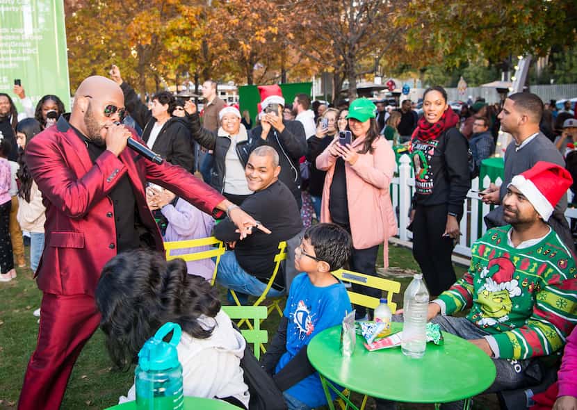 Emerald City Band's Bishop Booker works the crowd at this year's Klyde Warren Park tree...