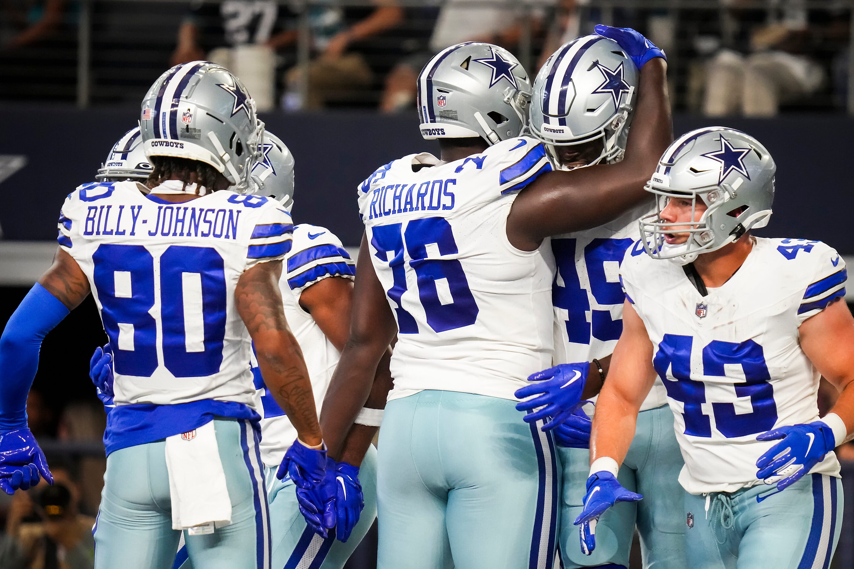 Dallas Cowboys wide receiver John Stephens Jr. (49) celebrates with offensive lineman Asim...