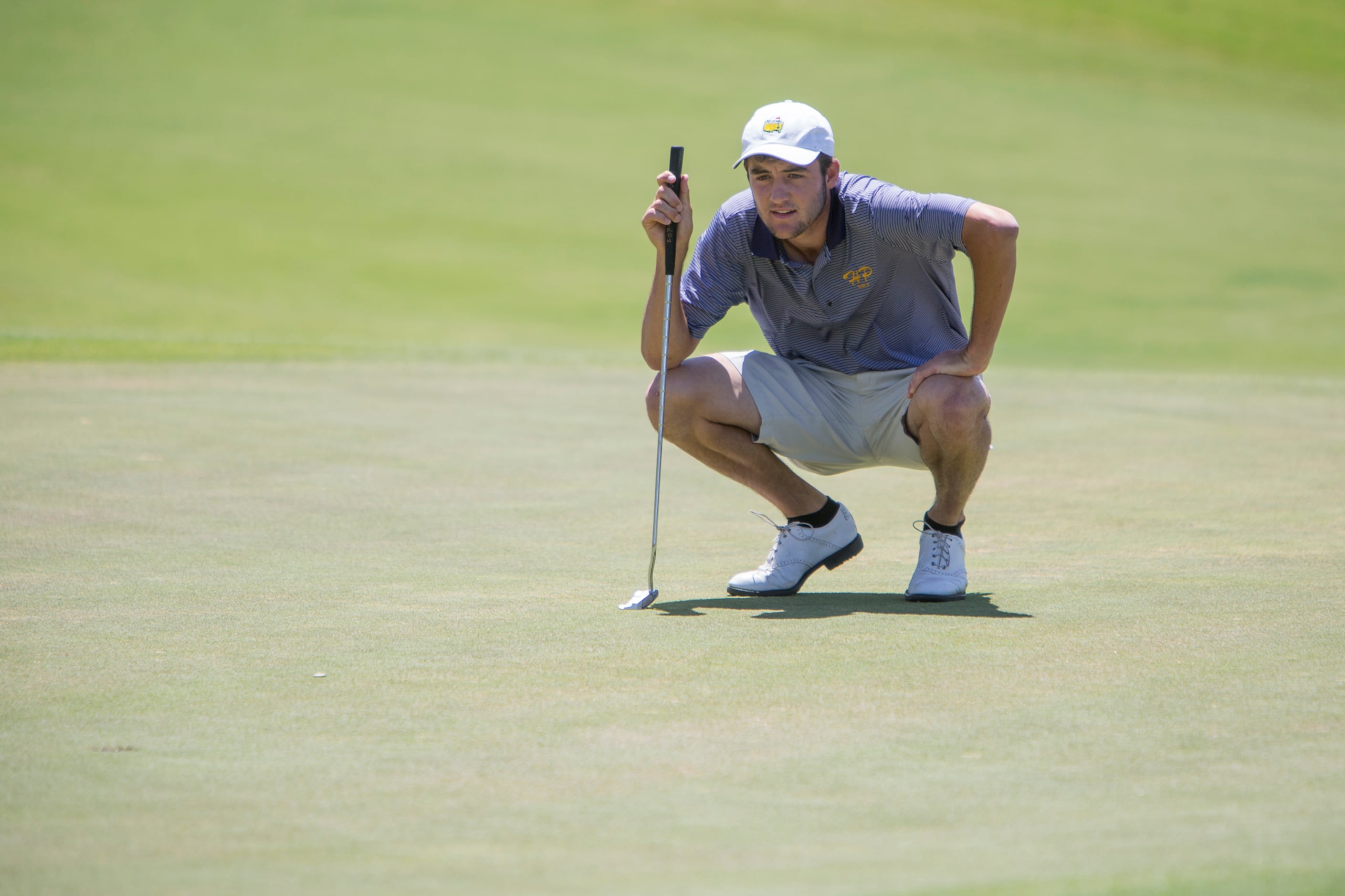 Highland Park's Scottie Scheffler lines up a putt on the first green during round two of the...