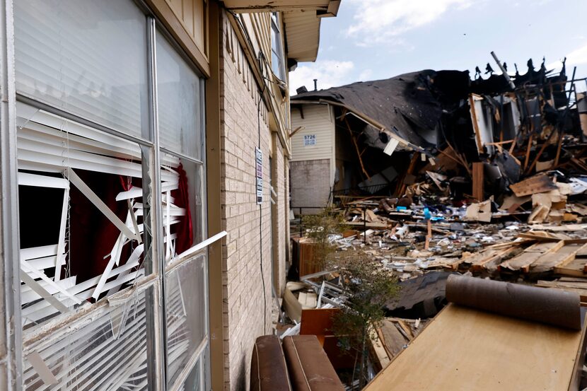 Blown-out windows are seen in adjacent building following an apartment explosion in the 5700...