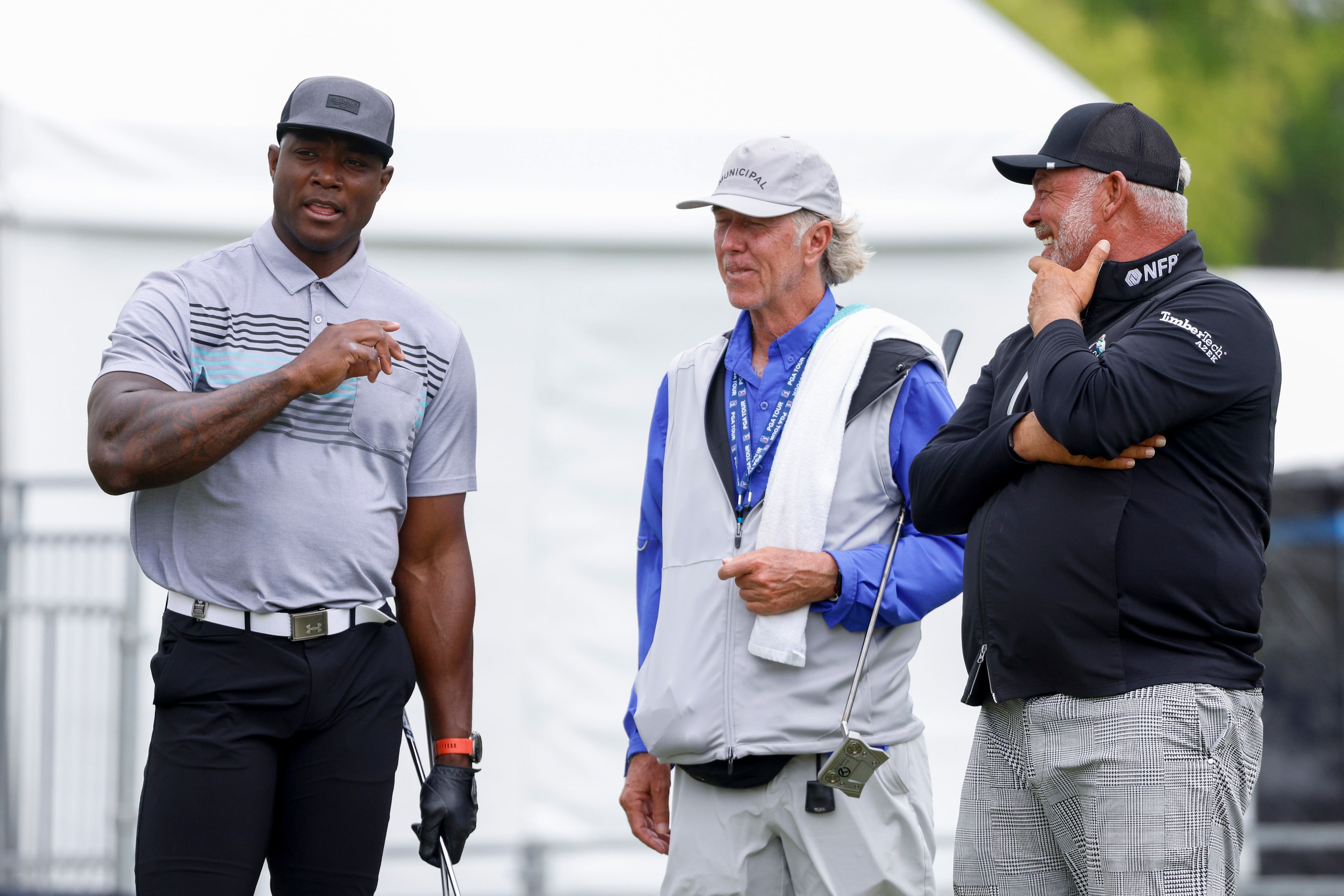 Former Dallas Cowboys player DeMarcus Ware (left) speaks with professional golfer Darren...