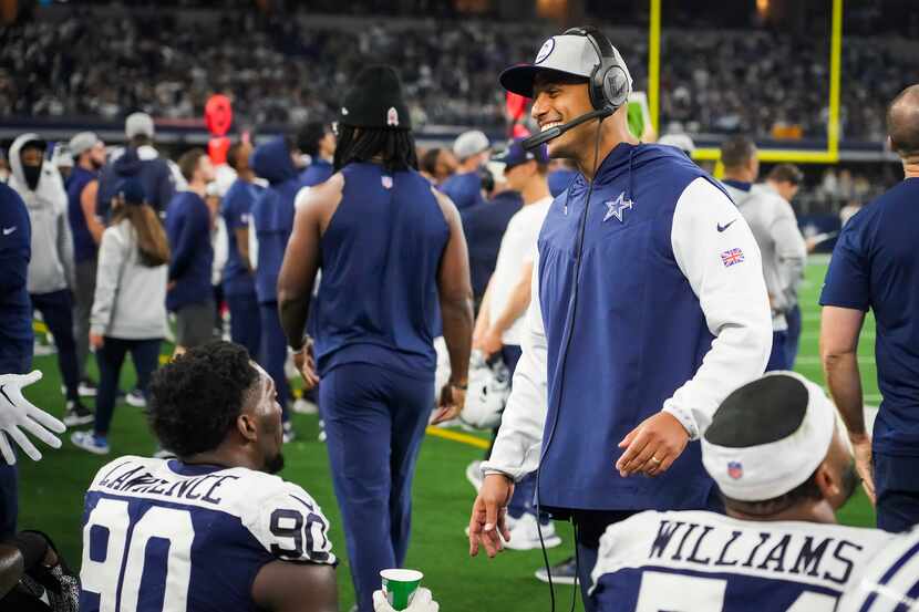 Dallas Cowboys defensive line coach Aden Durde laughs with defensive end DeMarcus Lawrence...