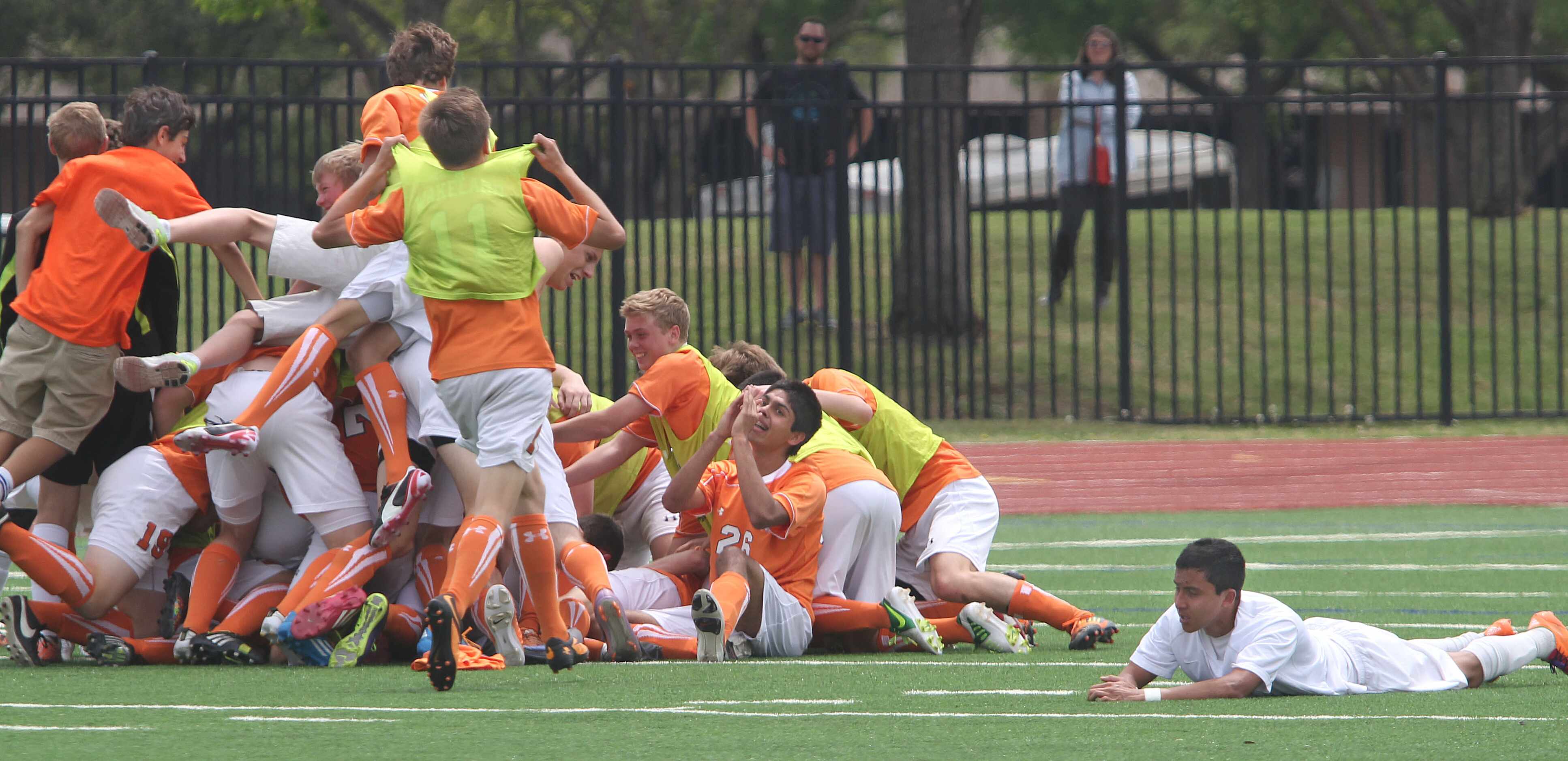 Frisco Wakeland players pile onto the field in celebration after beating Frisco Liberty