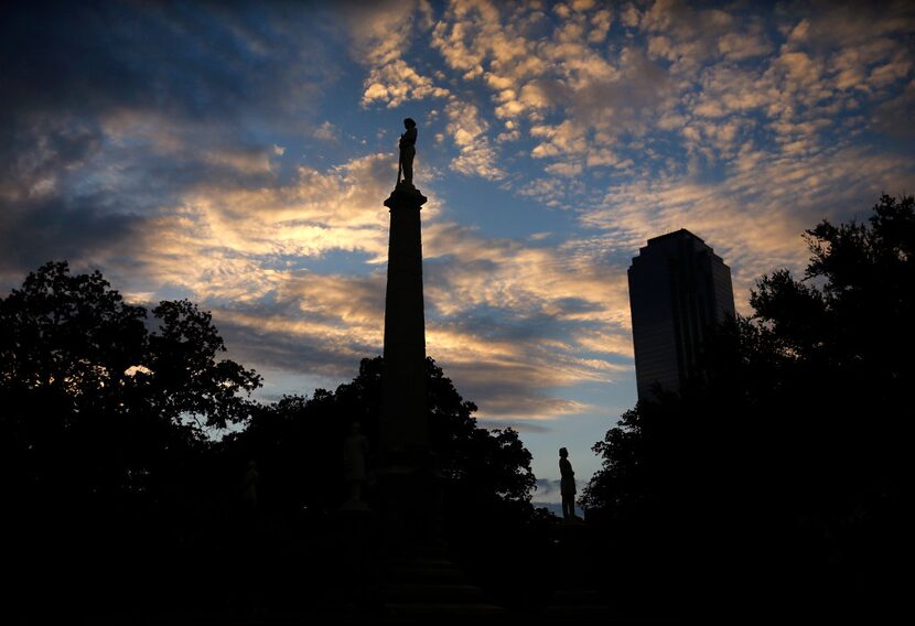 The Confederate War Memorial in Pioneer Park cemetery is seen at sunset in downtown Dallas,...