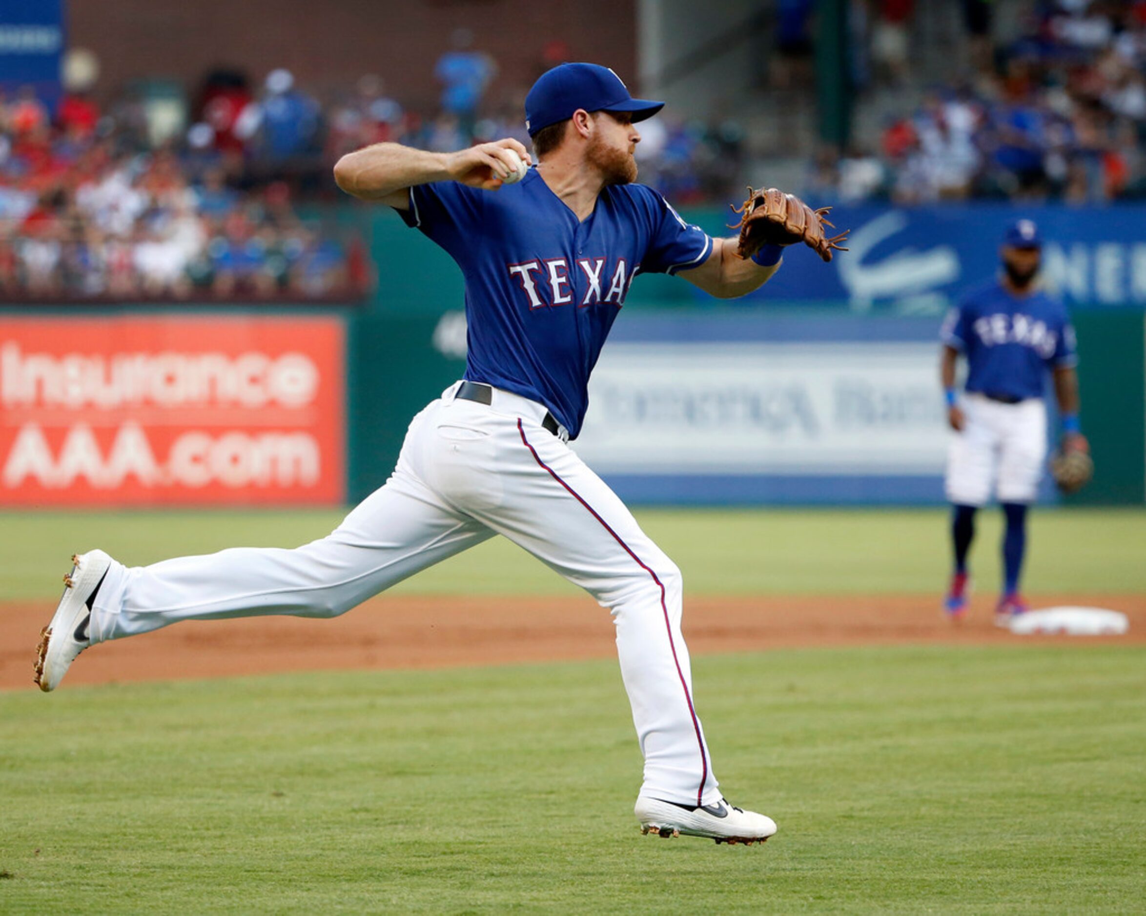 Texas Rangers first baseman Logan Forsythe (41) fields and throws put Houston Astros third...