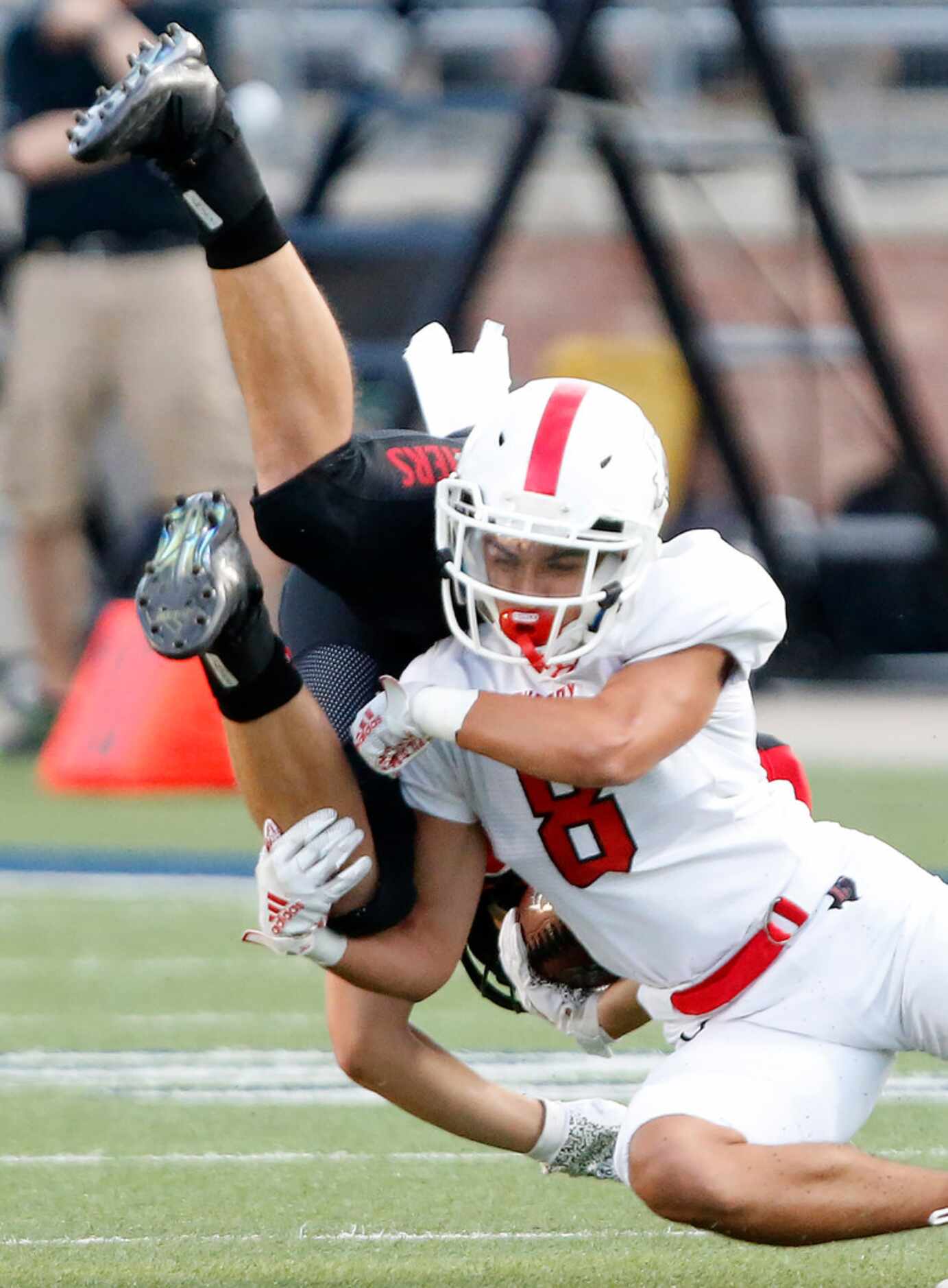 Colleyville Heritage High School running back Braxton Ash (29) is upended by Lovejoy High...