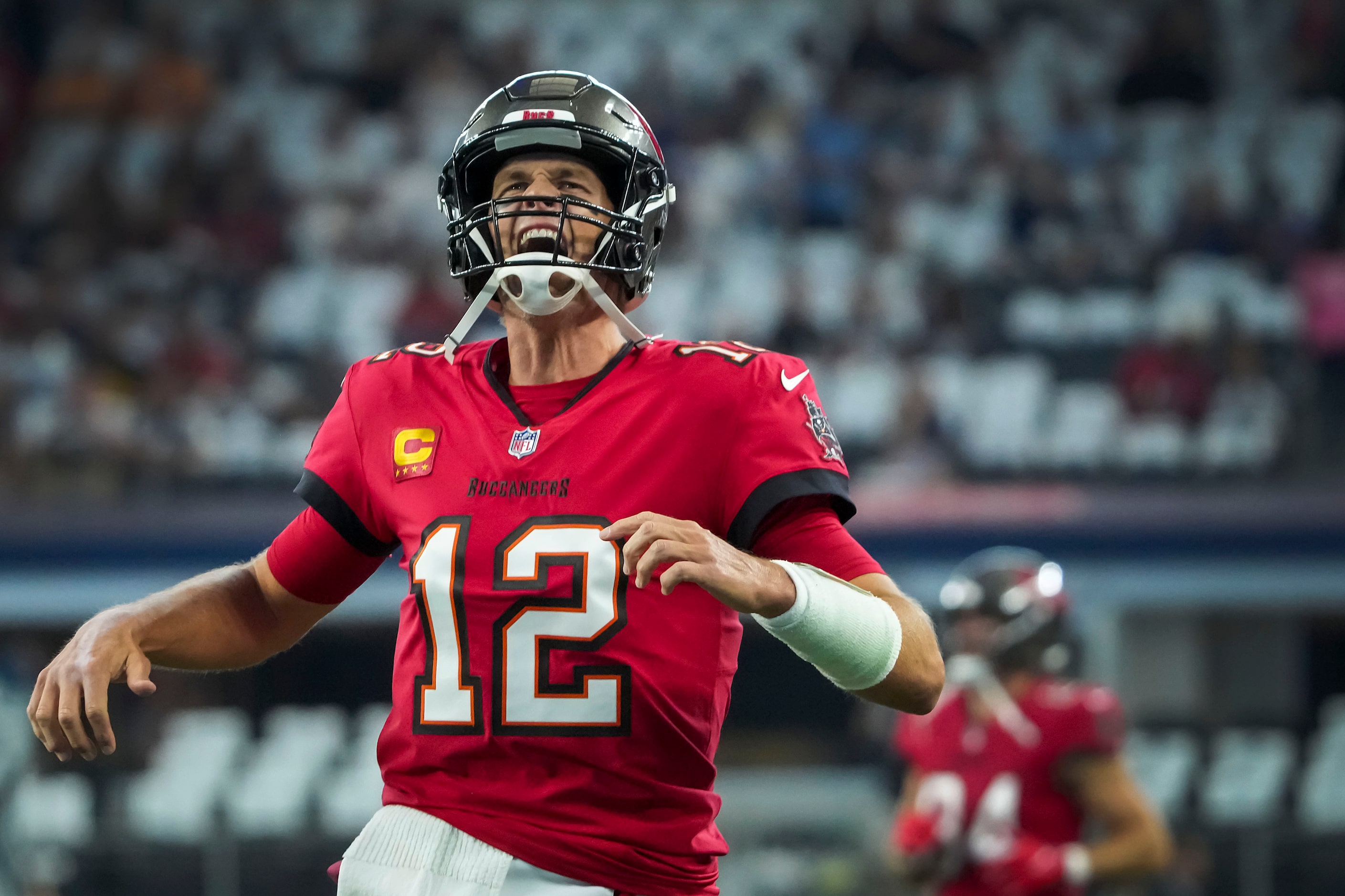 Tampa Bay Buccaneers quarterback Tom Brady yells toward the crowd as he take the field to...