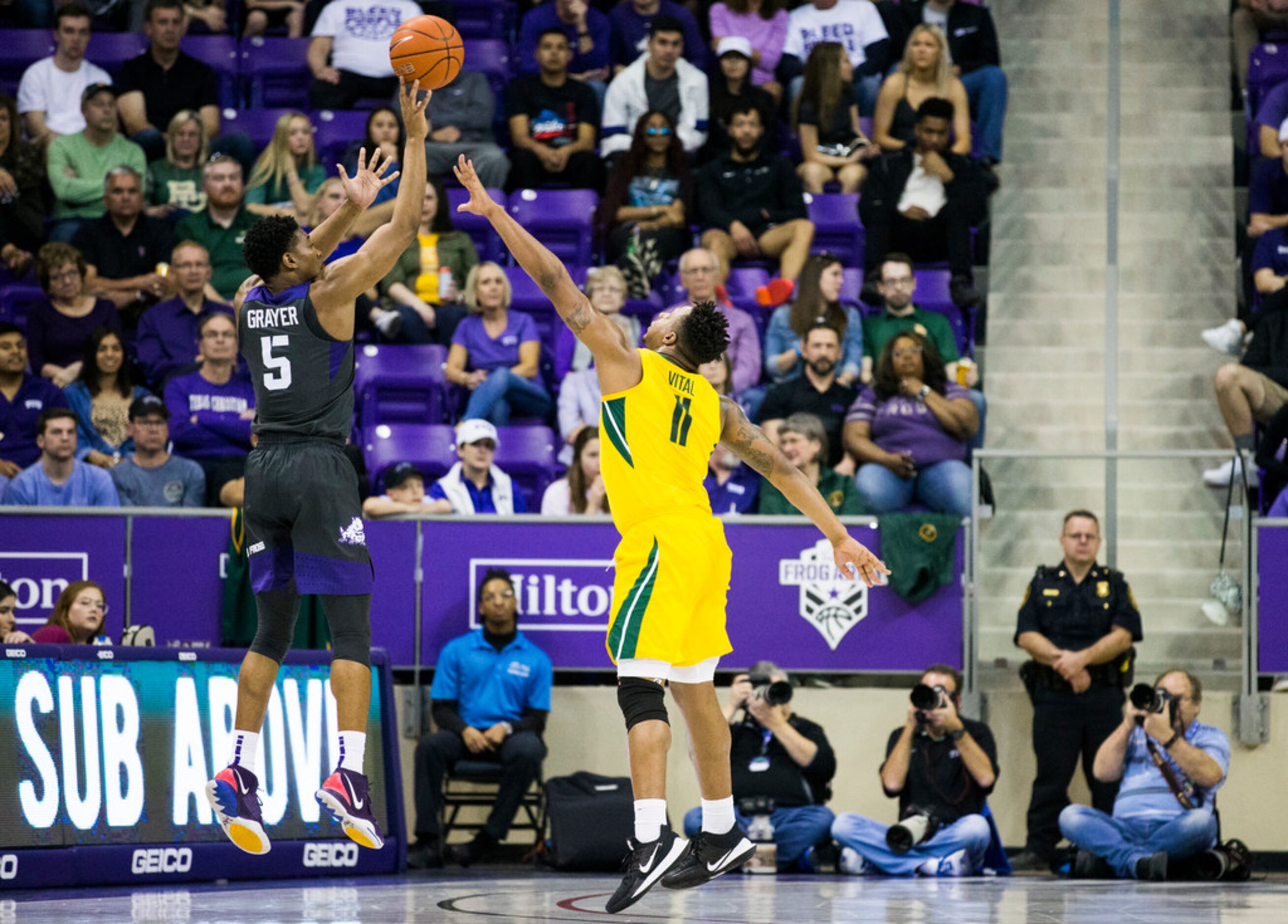 TCU Horned Frogs guard Jaire Grayer (5) takes a shot over Baylor Bears guard Mark Vital (11)...