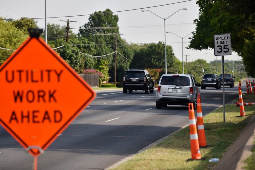 A utility work sign posted near Midway and Northaven roads alerts residents to gas line...