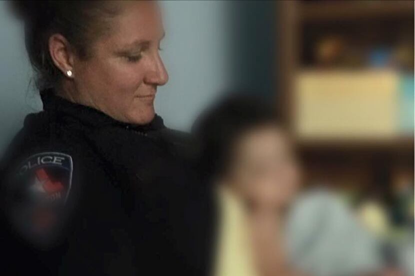 Arlington Officer Nikki Newton comforted a 2-year-old boy while police tried to find his...