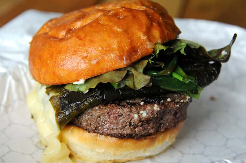 The poblano burger features grilled poblano, queso oaxaca, green onions and cilantro mayo at...