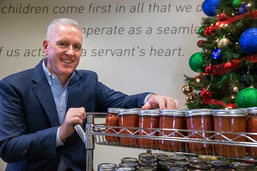 President and CEO Lynn Davis poses for a portrait with jars of his homemade salsa at Dallas...