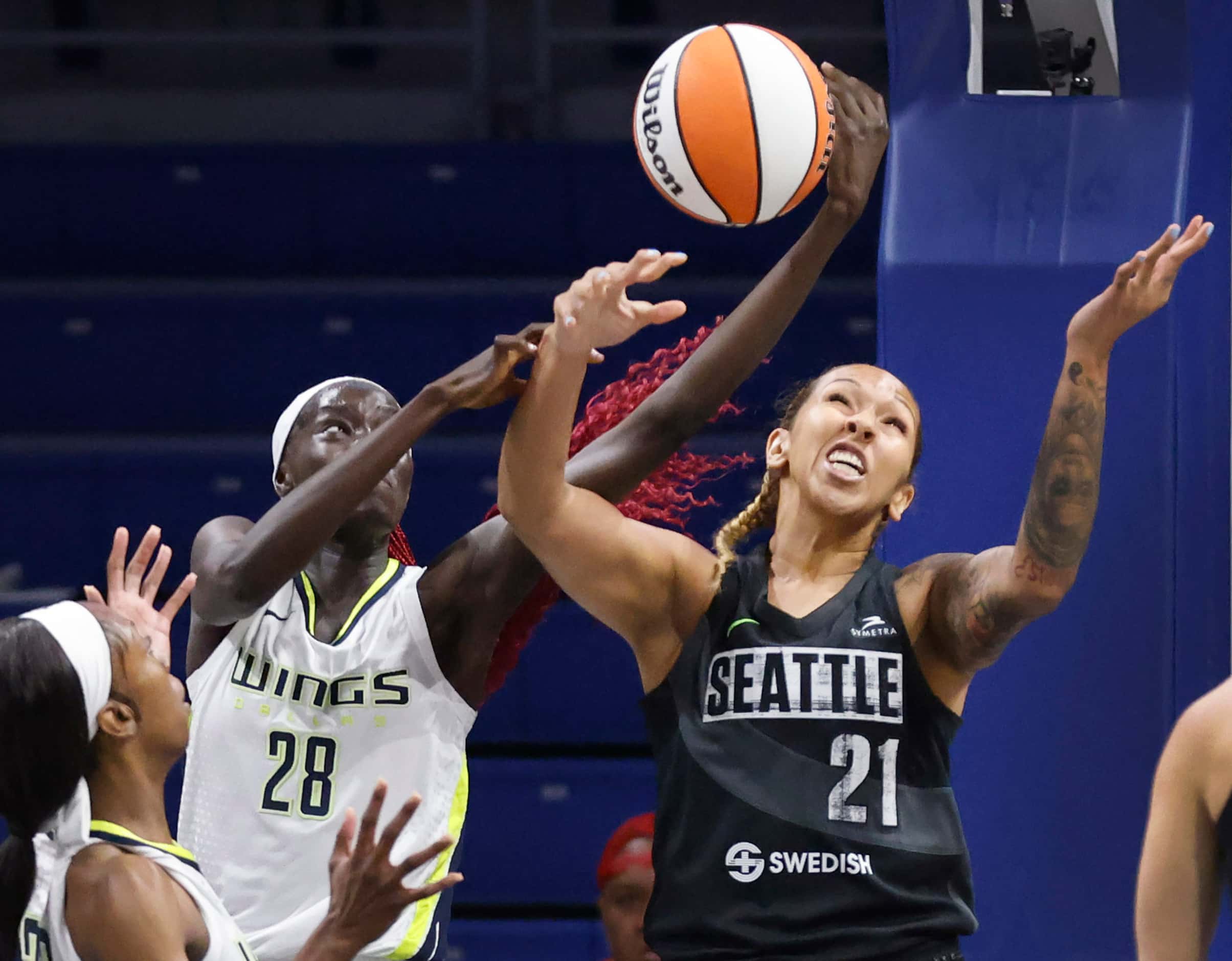 Dallas Wings center Awak Kuier (28) and Seattle Storm center Mercedes Russell (21) battle...