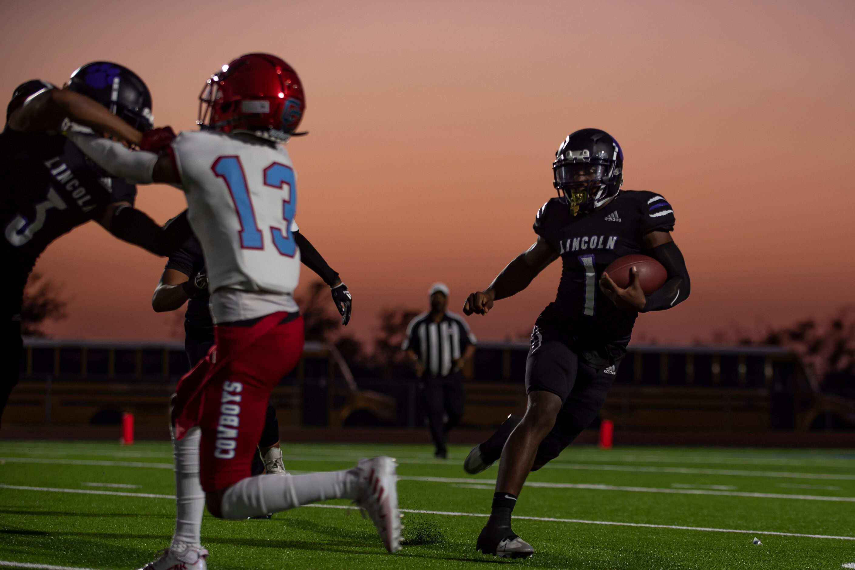 Lincoln senior Jaden Cole (1) runs across the field to gain yardage during a high school...