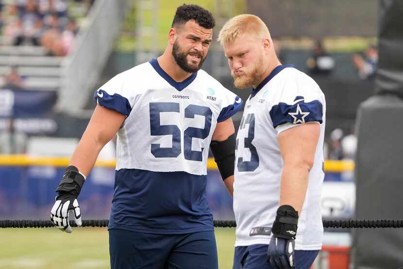 Dallas Cowboys guard Connor Williams (52) and center Tyler Biadasz (63) stretch during a...