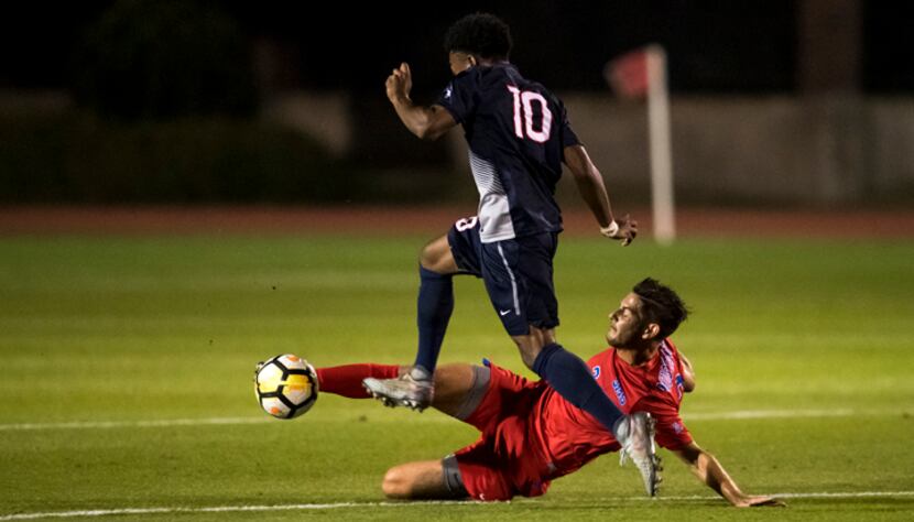 Jordan Cano, #2 of SMU, tackles a Connecticut striker in the 1-0 SMU win that clinched the ...
