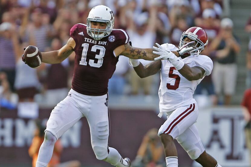 Texas A&M Aggies wide receiver Mike Evans (13) fights off Alabama defensive back Cyrus Jones...