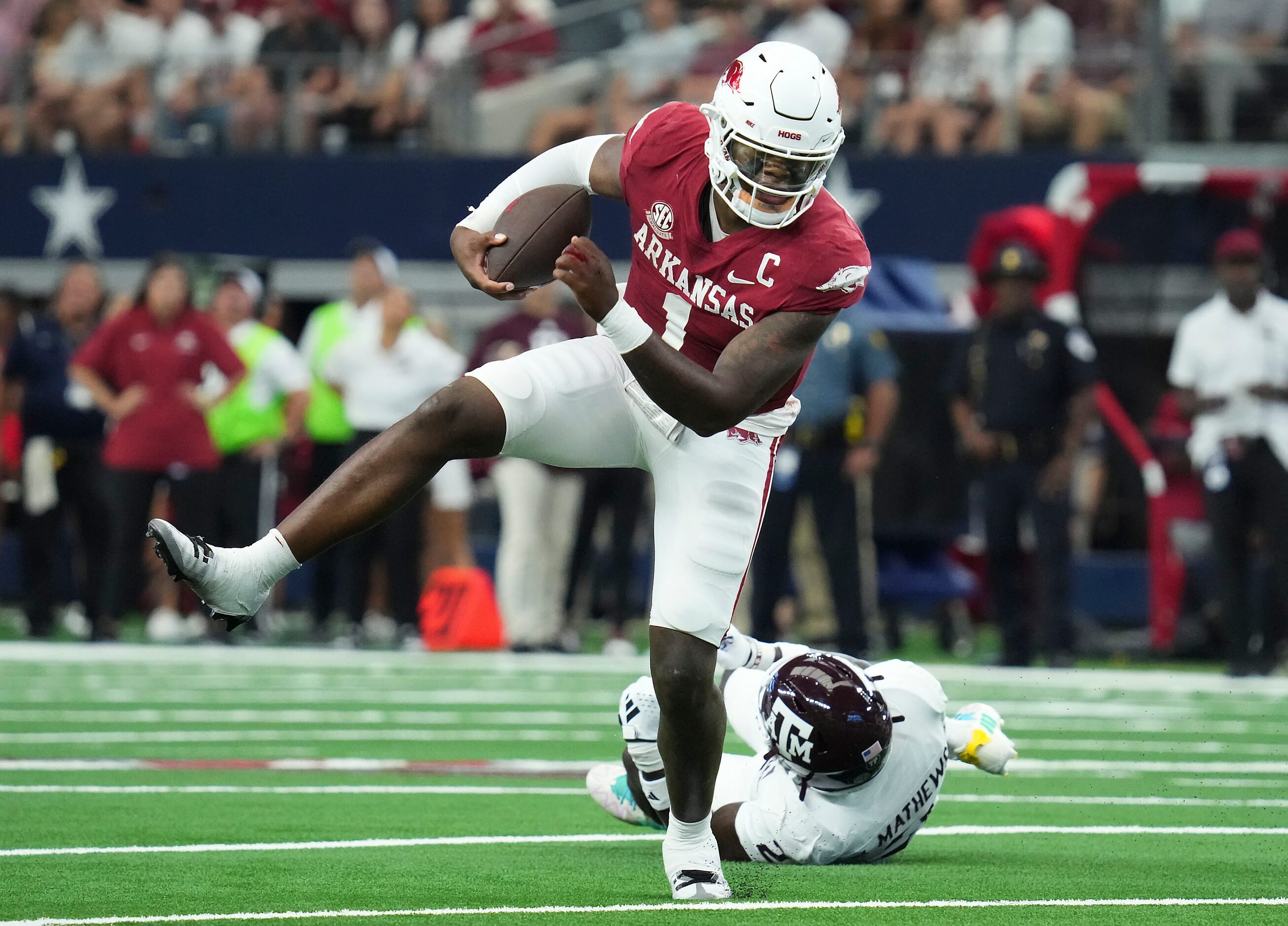 Arkansas quarterback KJ Jefferson (1) gets past Texas A&M defensive back Jacoby Mathews (2)...