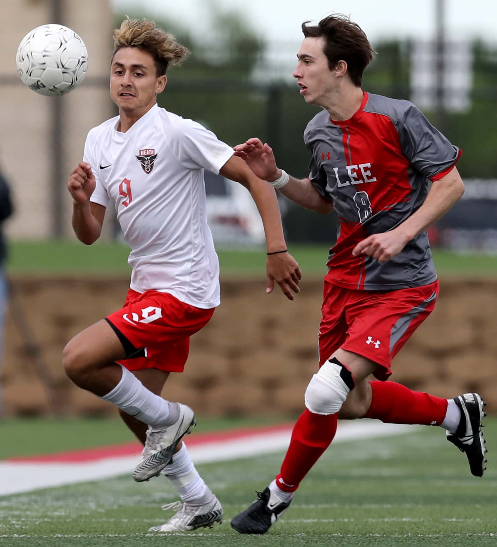 Rockwall-Heath's Chuy Ruiz (9) and SA Lee's Gavin Seesholtz (8) chase after the ball during...