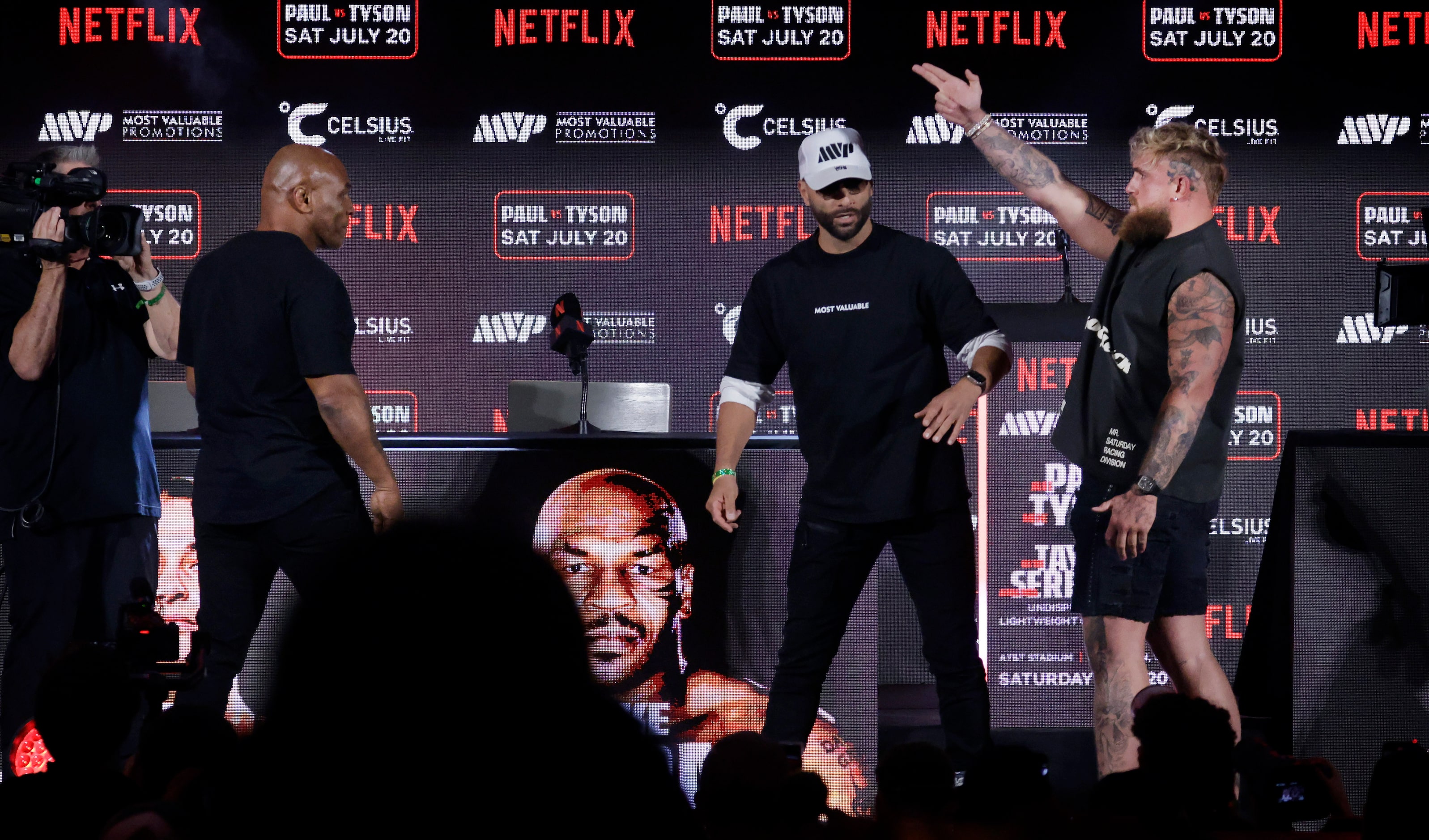 Ahead of their July fight at AT&T Stadium, boxers Mike Tyson (left) reacts to the advances...