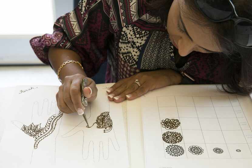 Farah Tharani practices henna in a basic henna class at Carrollton Public Library