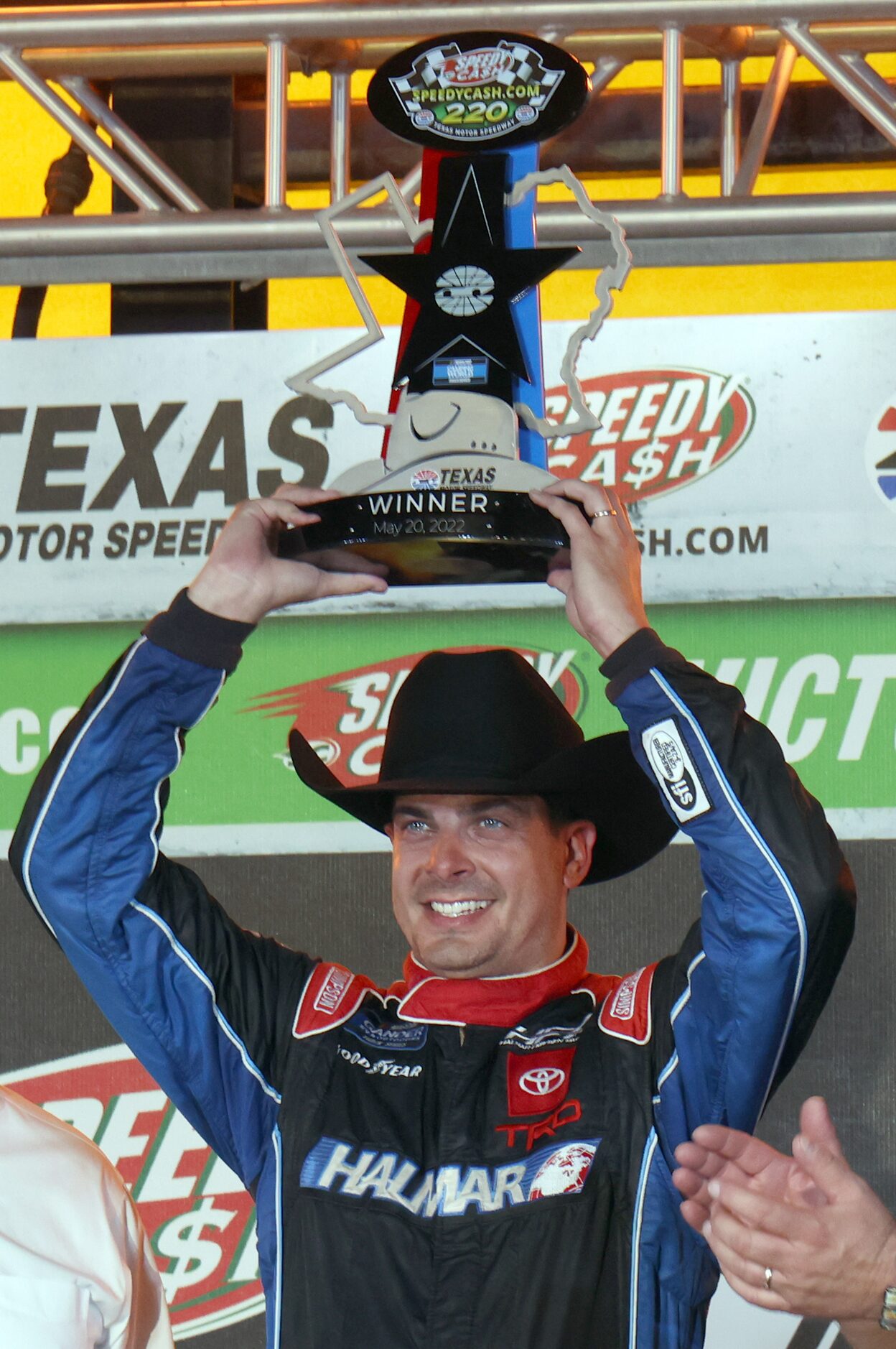 Driver Stewart Friesen hoists the winning trophy after his come-from-behind victory in the...