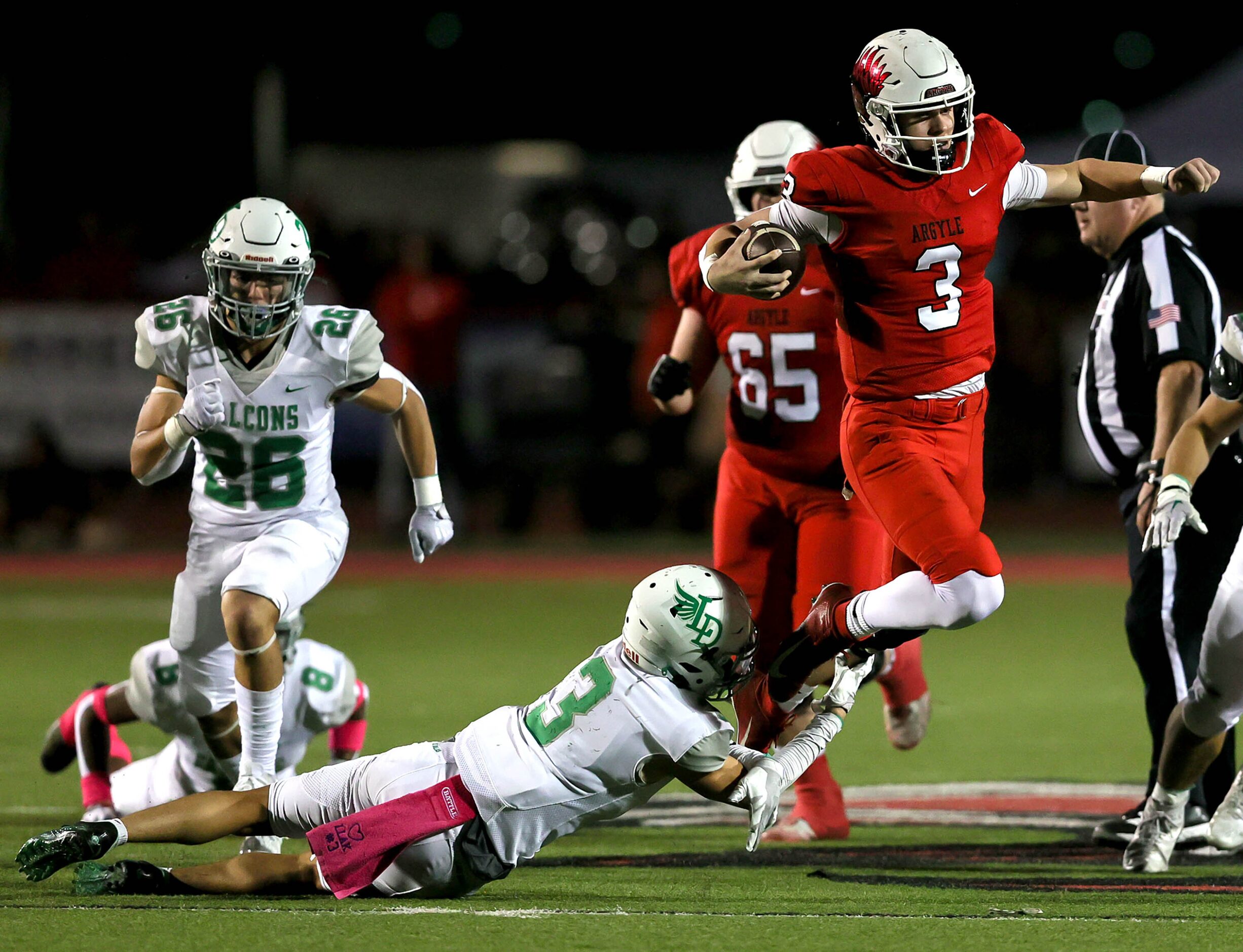 Argyle quarterback Jacob Robinson (3) tries to break a tackle against Lake Dallas defensive...