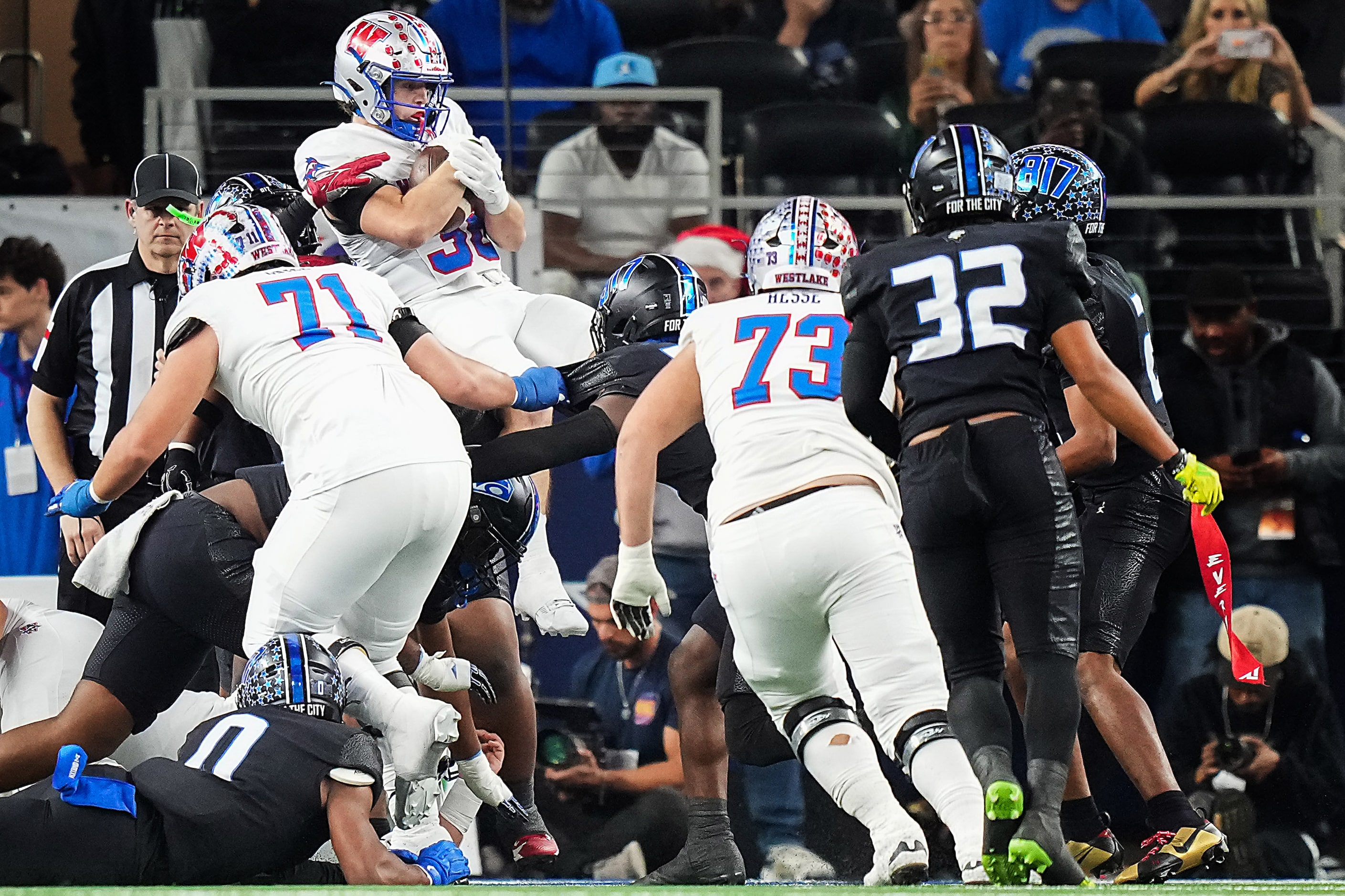 Austin Westlake’s Grady Bartlett goes over the top on a 2-yard touchdown run during the...