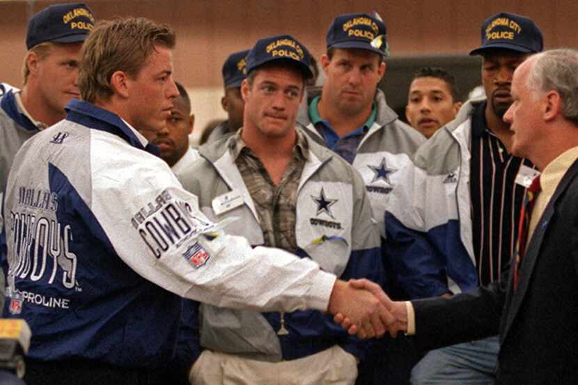  April 28, 1995--Dallas Cowboys quarterback Troy Aikman, left, shakes hands with Oklahoma...