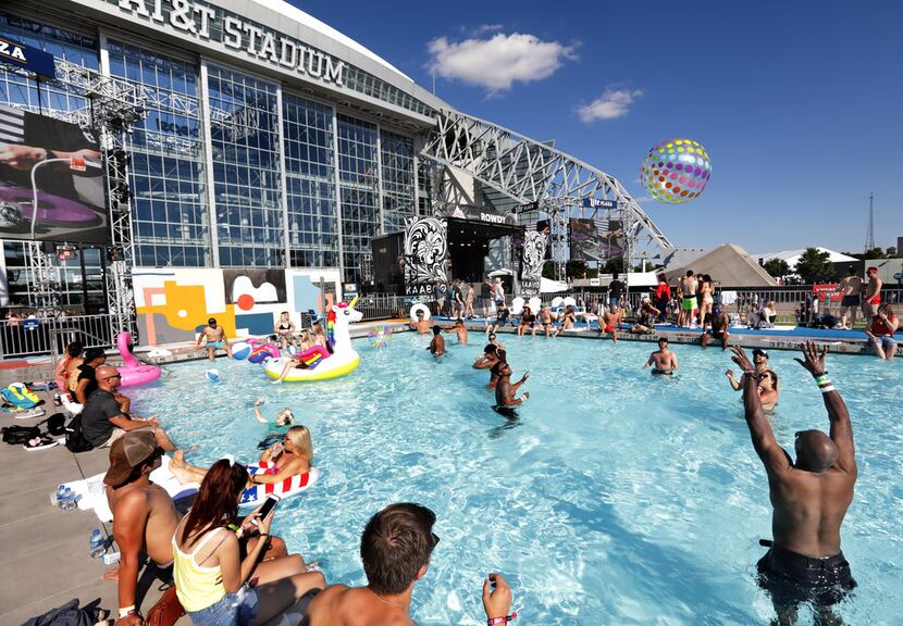 Guests enjoy the pool as Mix Master Mike performs during Kaaboo Texas at AT&T Stadium in...
